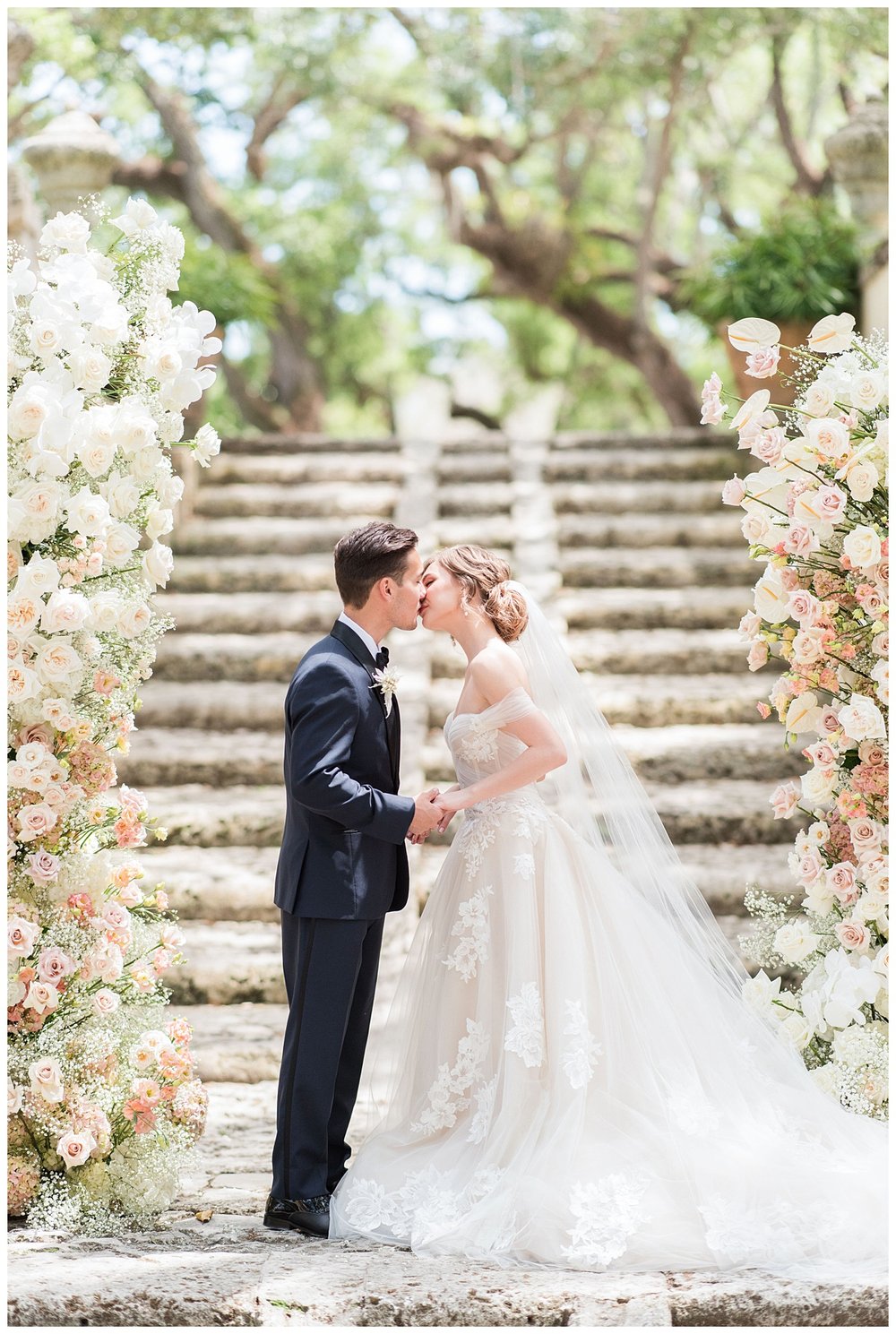 bride and groom standing on stairs at Miami Vizcaya Museum Wedding ceremony kissing