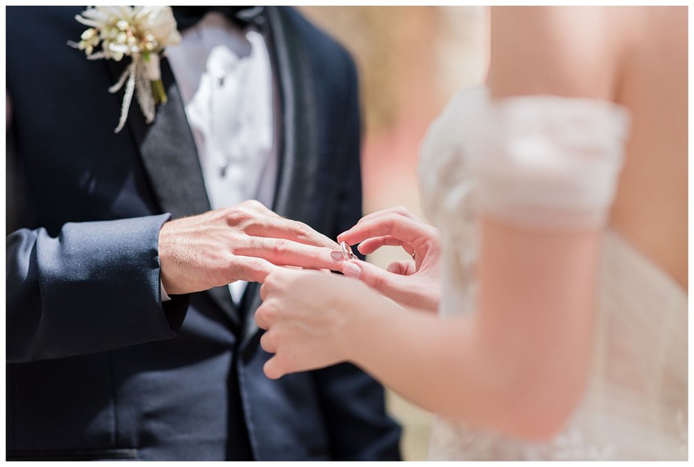 outdoor Miami wedding ceremony ring exchange hands detailed image
