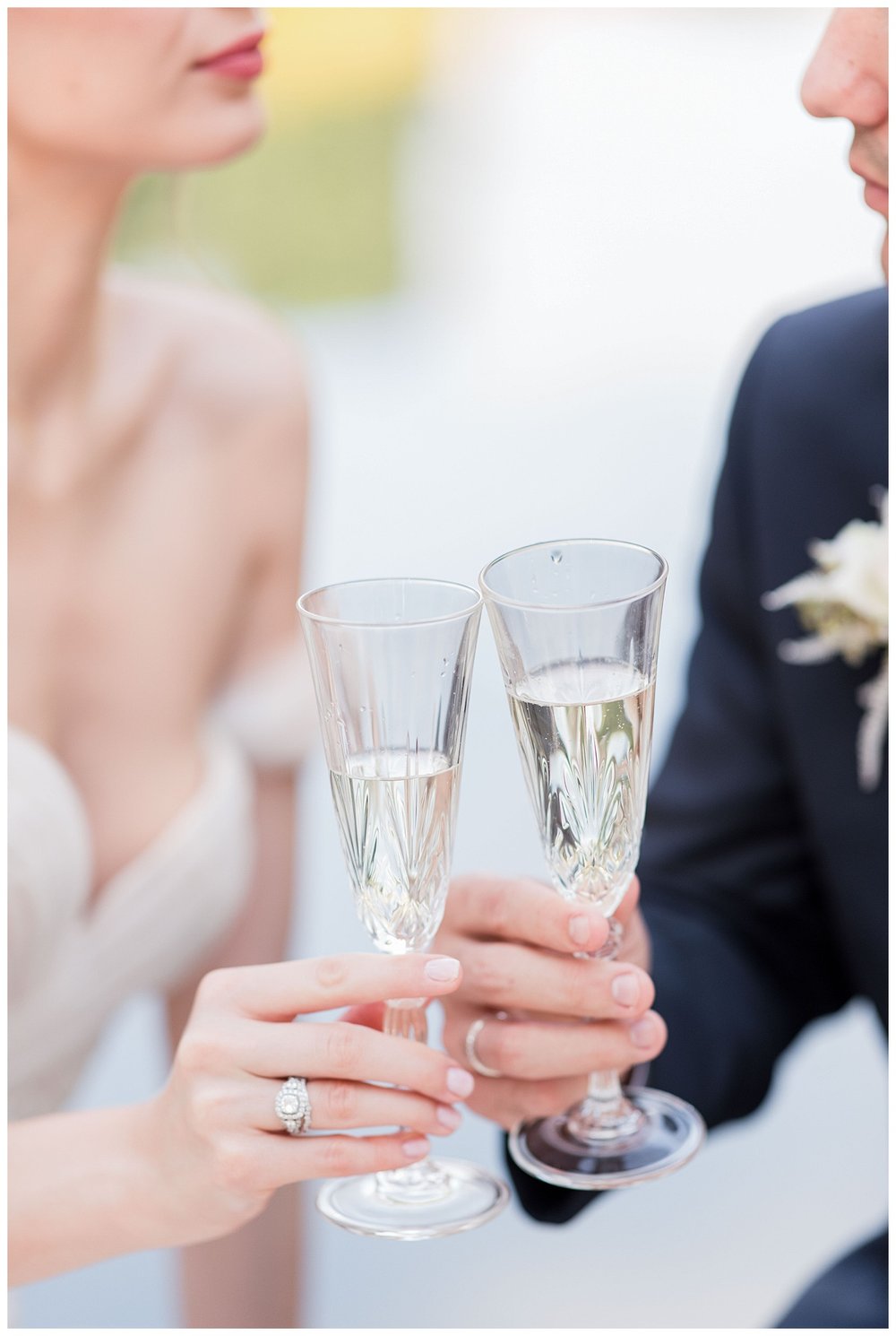 detail shot of bride and groom champagne glass toast