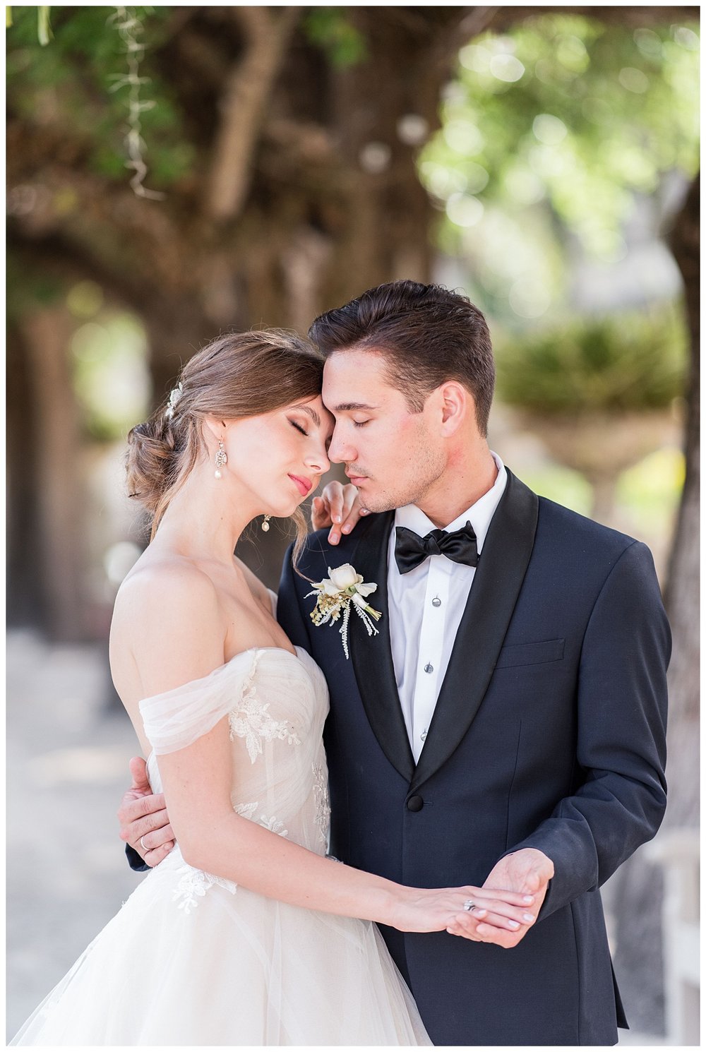 bride and groom nuzzling for outdoor wedding portrait