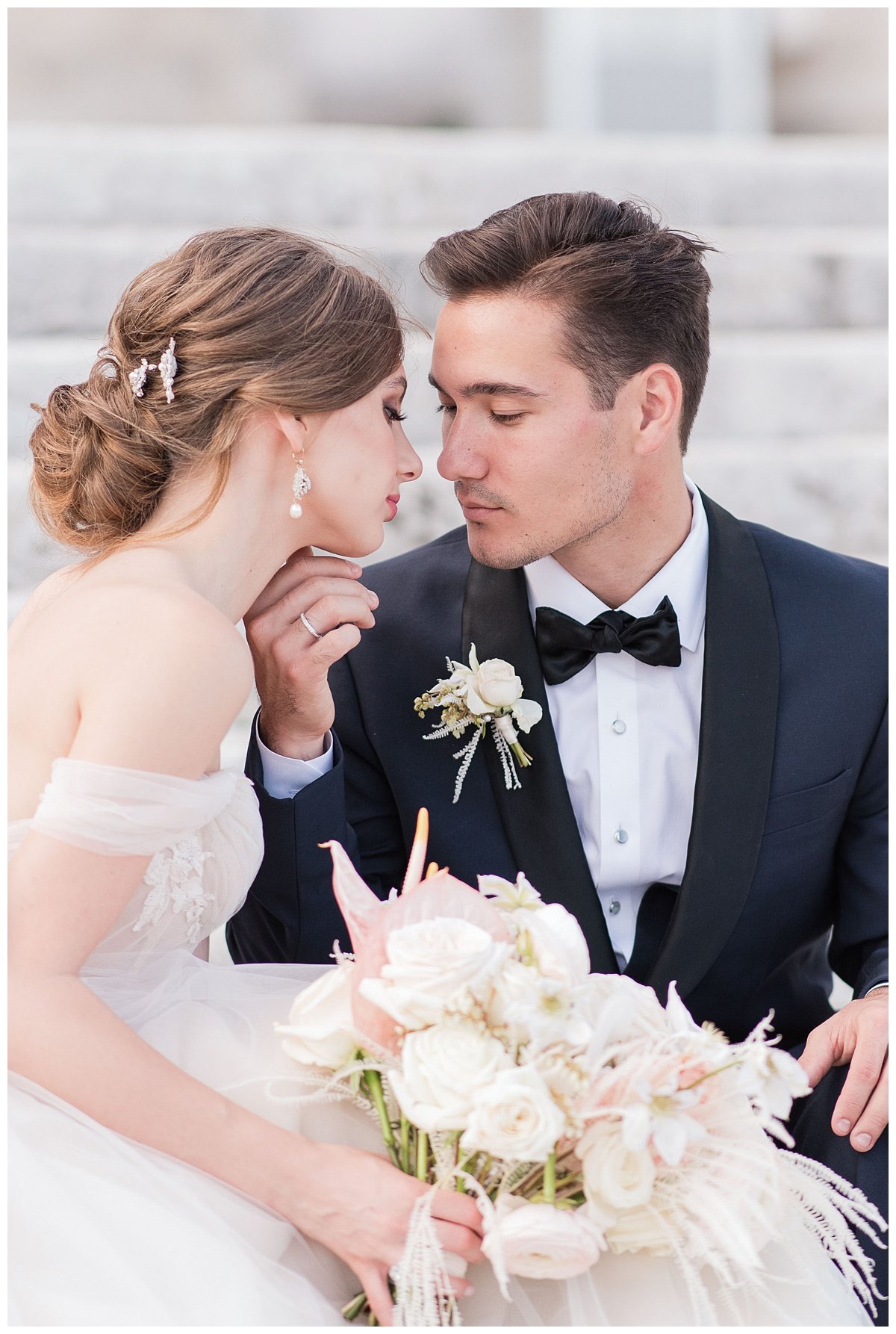 groom staring into brides eyes with hand on her chin sitting on steps at Miami Vizcaya Museum 