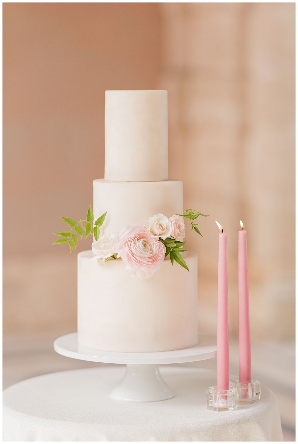 three tier white wedding cake with blush florals