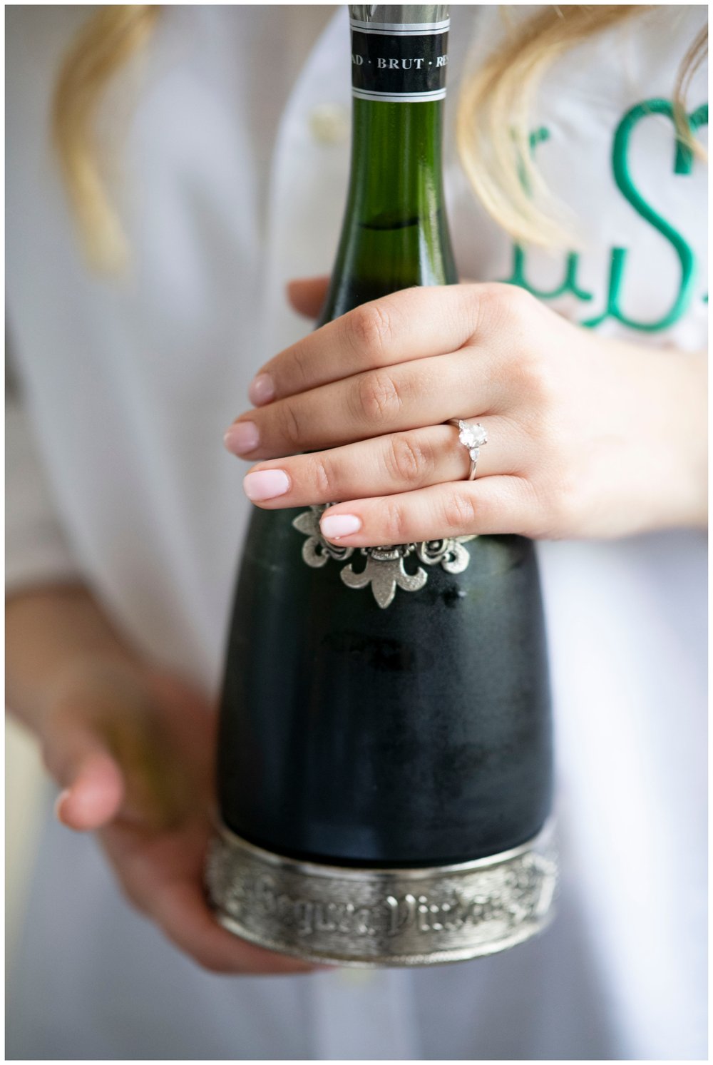 bride holding champagne bottle