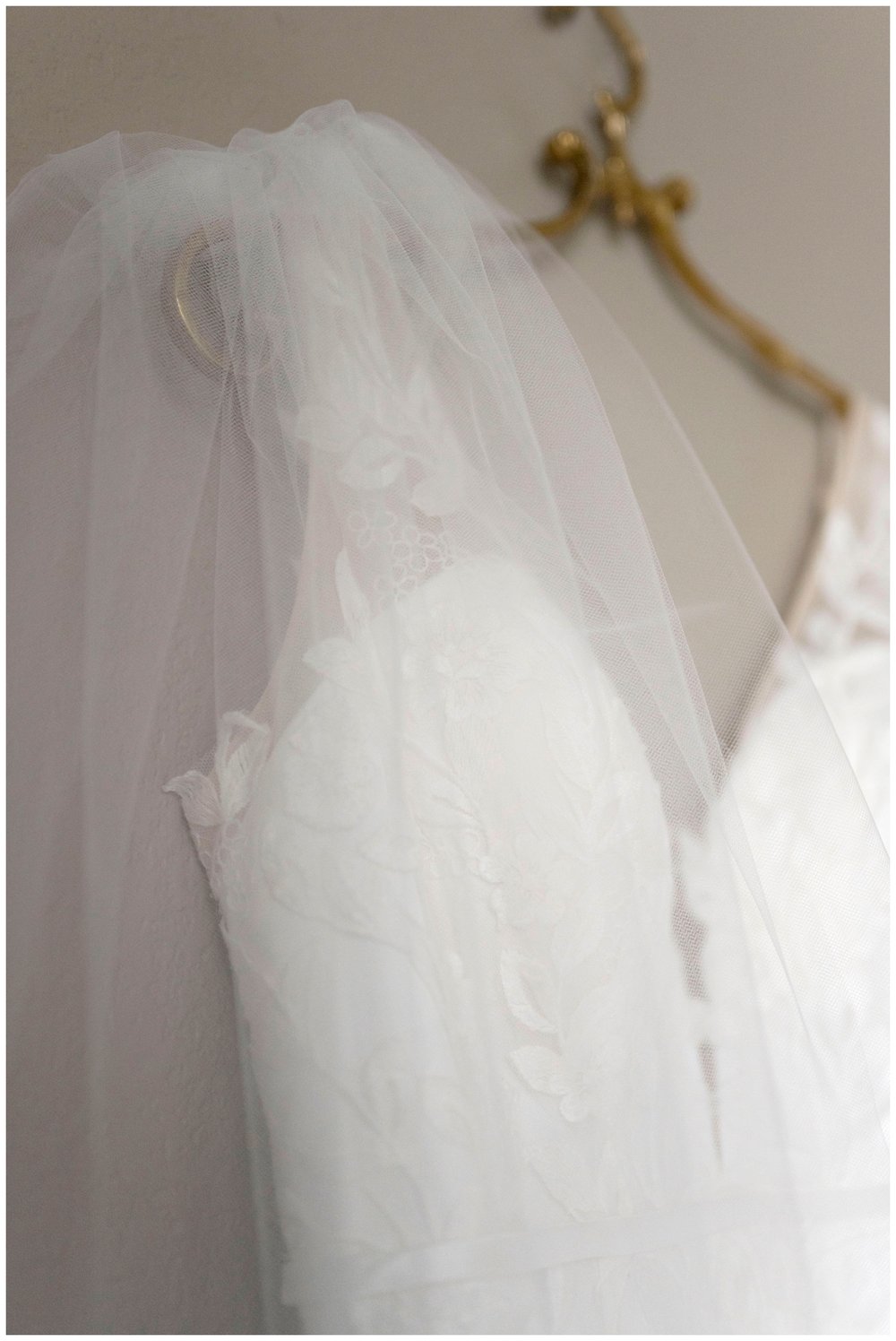 detailed image of white wedding gown on gold hangar New England wedding photographer