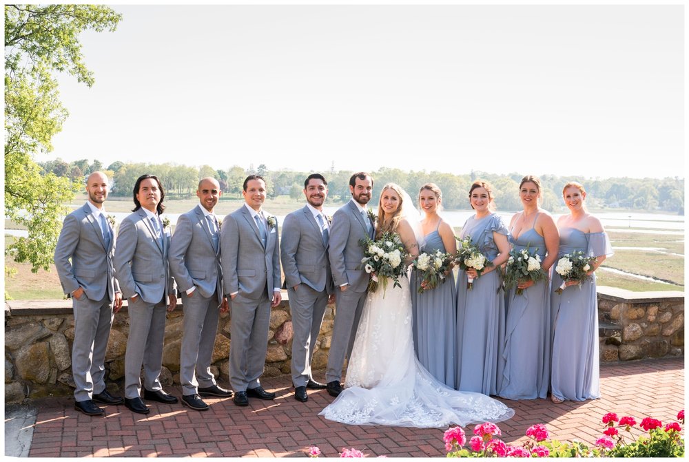 bridal party smiling outdoors at The River Club