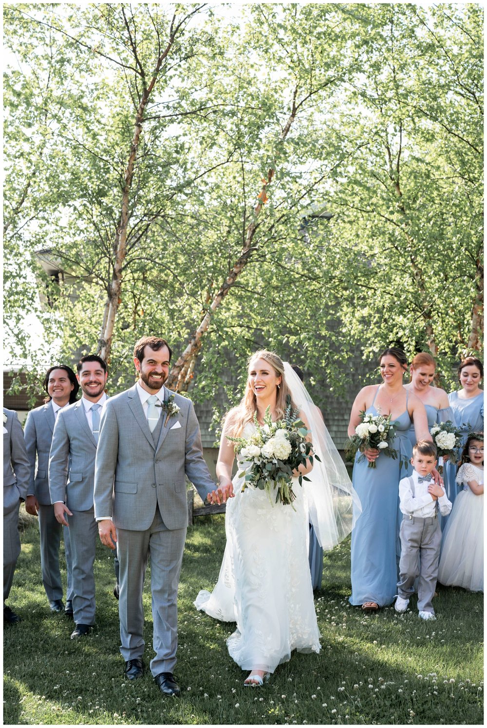 bride and groom holding hands outdoors and walking toward New England wedding photographer