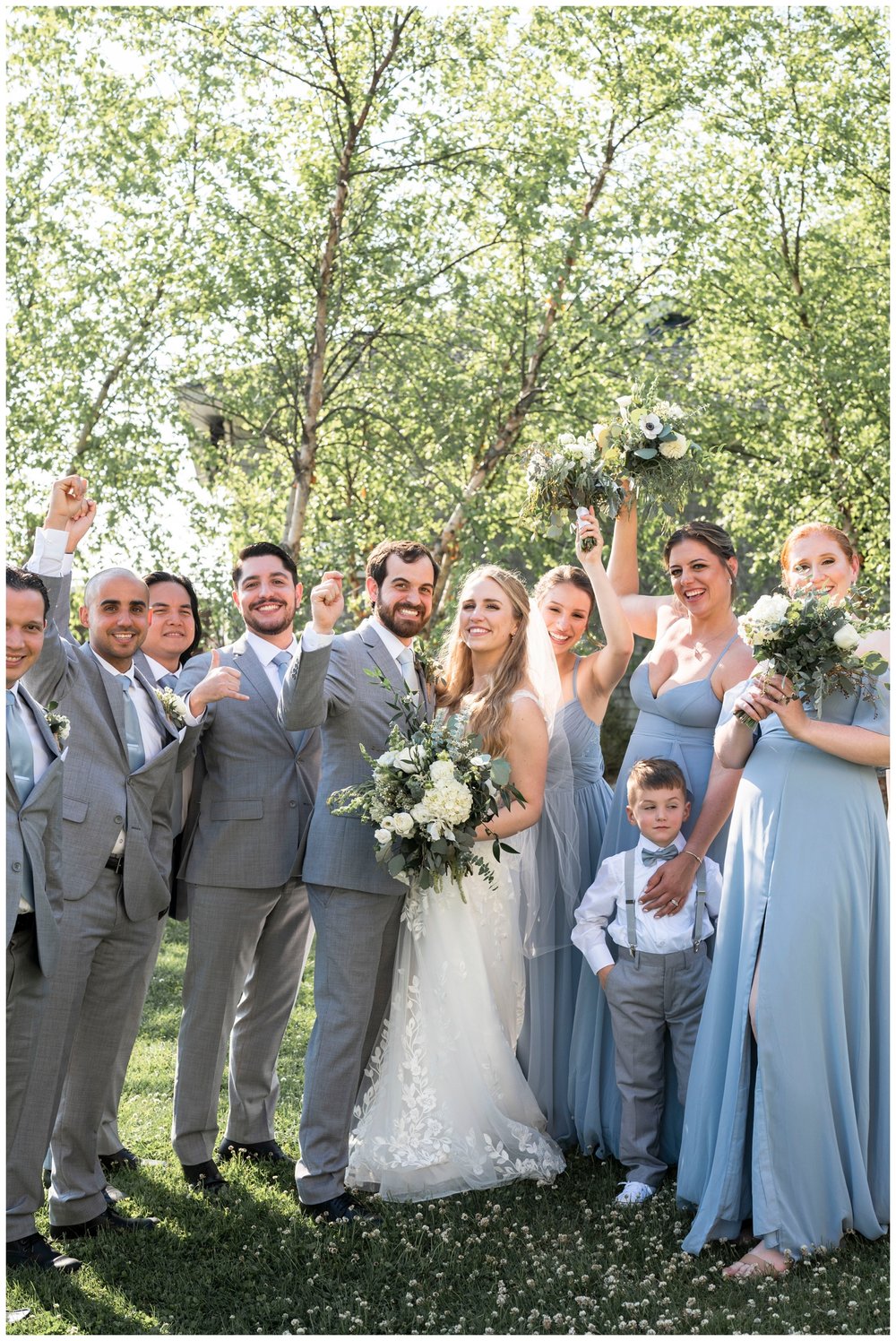 bride and groom portrait with wedding party