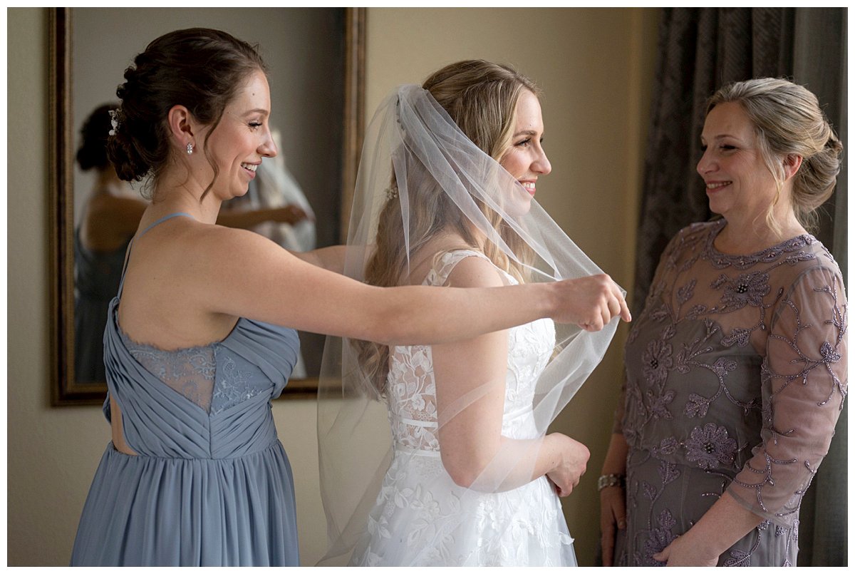 bride getting ready with mother of bride