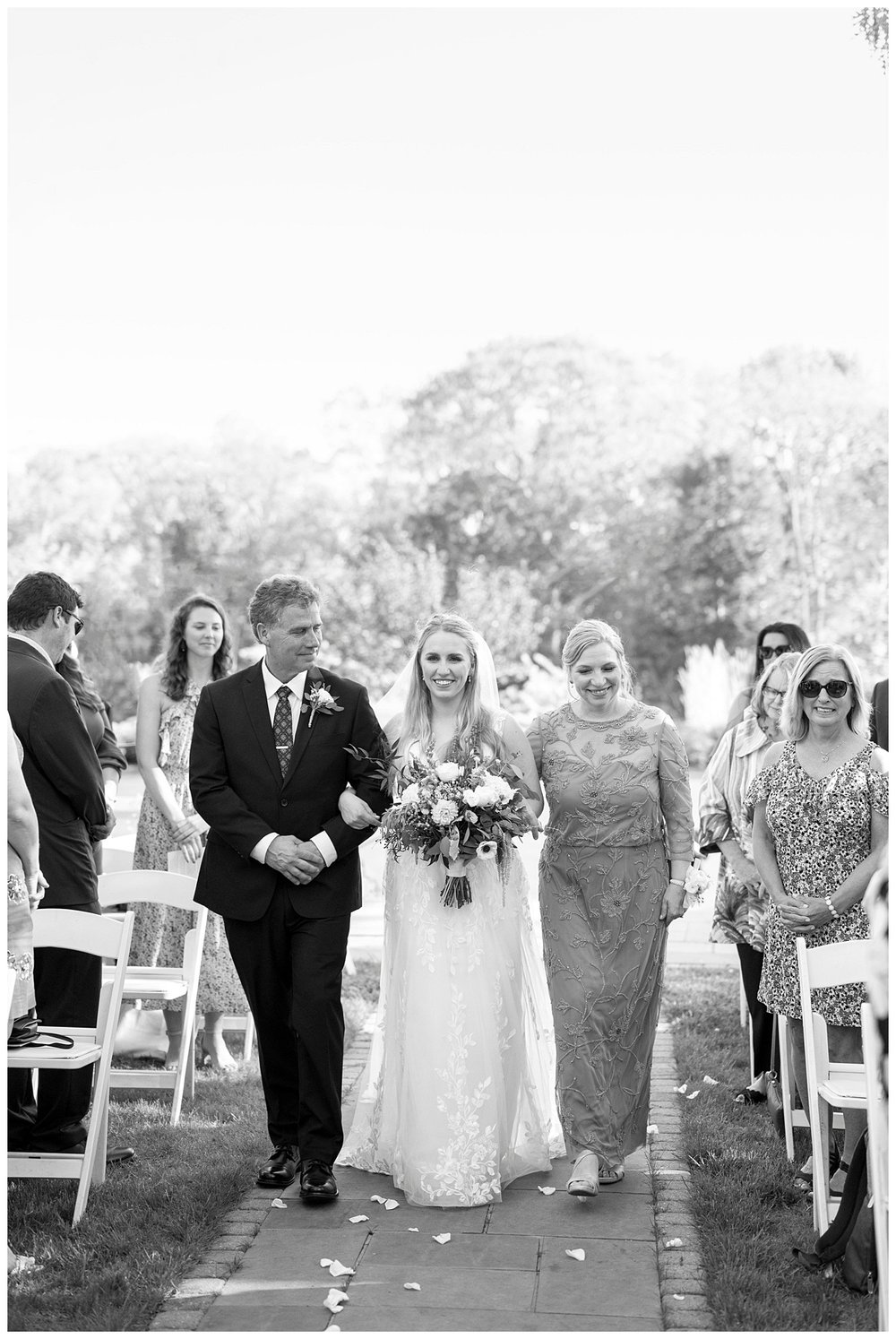 black and white image of bride walking down the aisle for New England wedding photographer