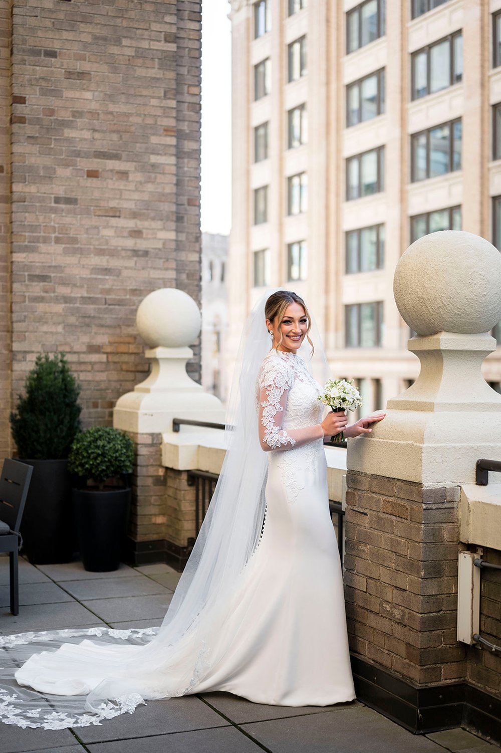bridal portraits on rooftop with lace wedding dress