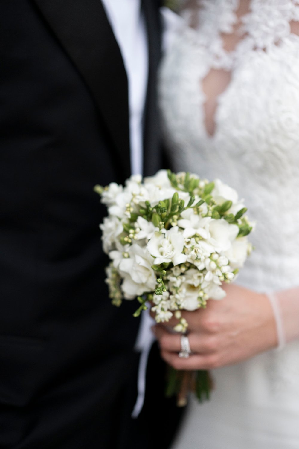 bride holding white wedding bouquet 