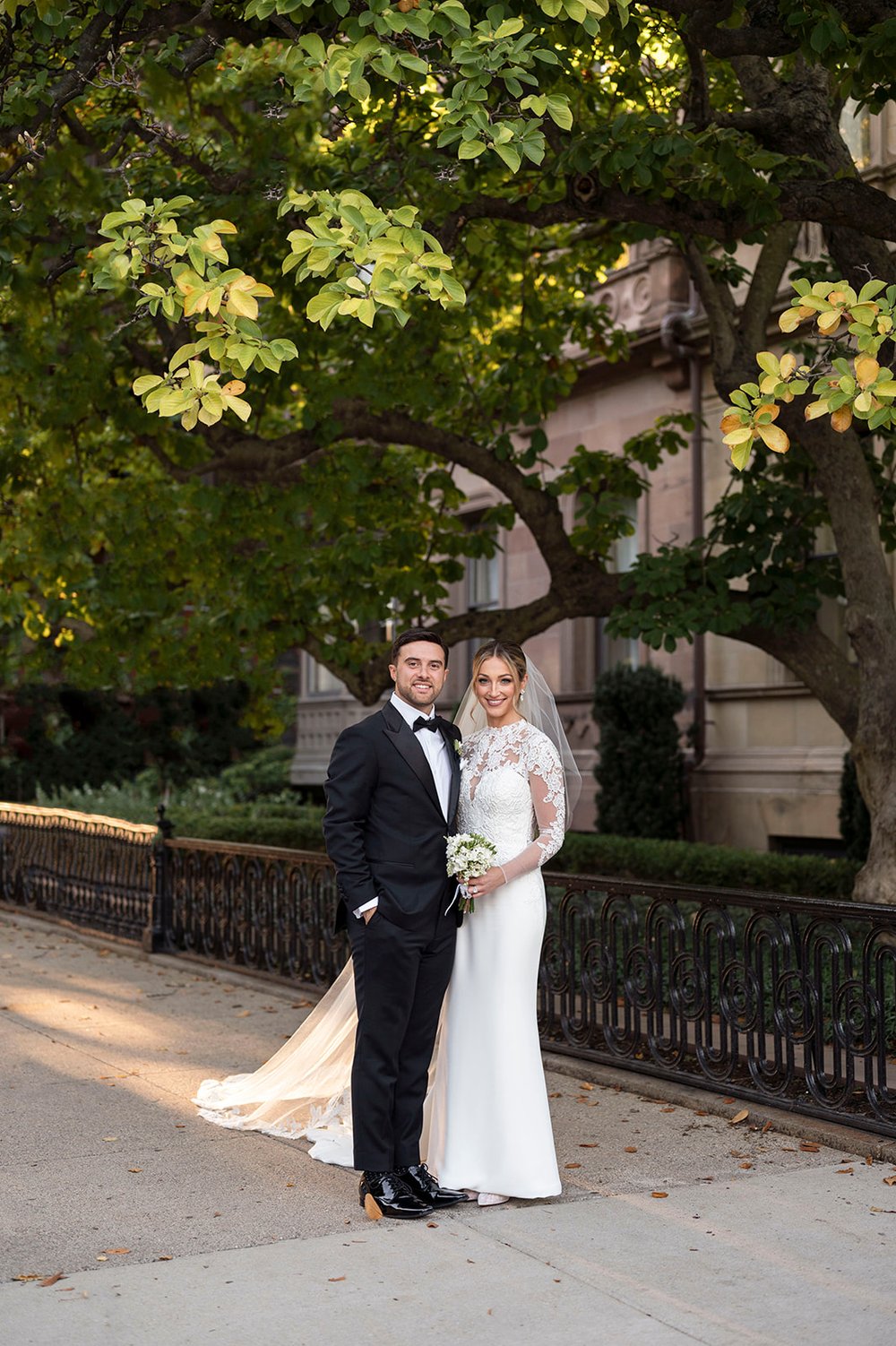 bride and groom posing at park plaza in boston