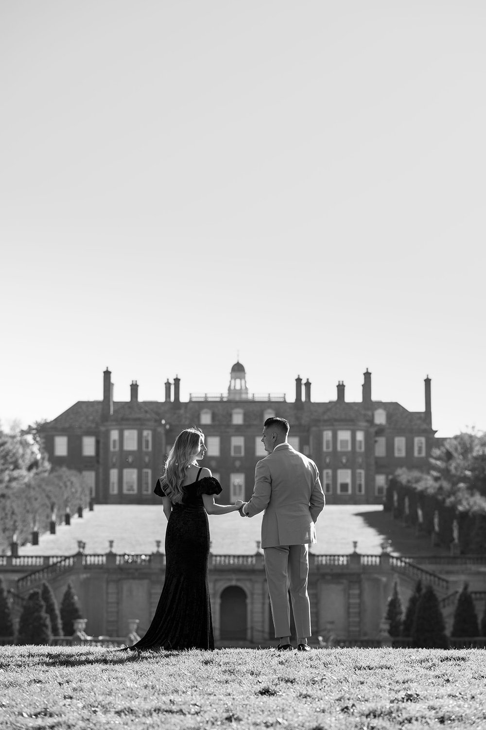 couple standing in front of pond at castle hill