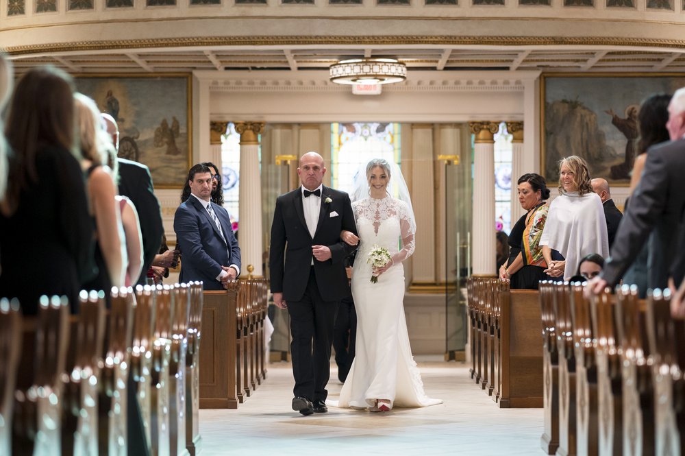 bride walking down aisle during church wedding in boston