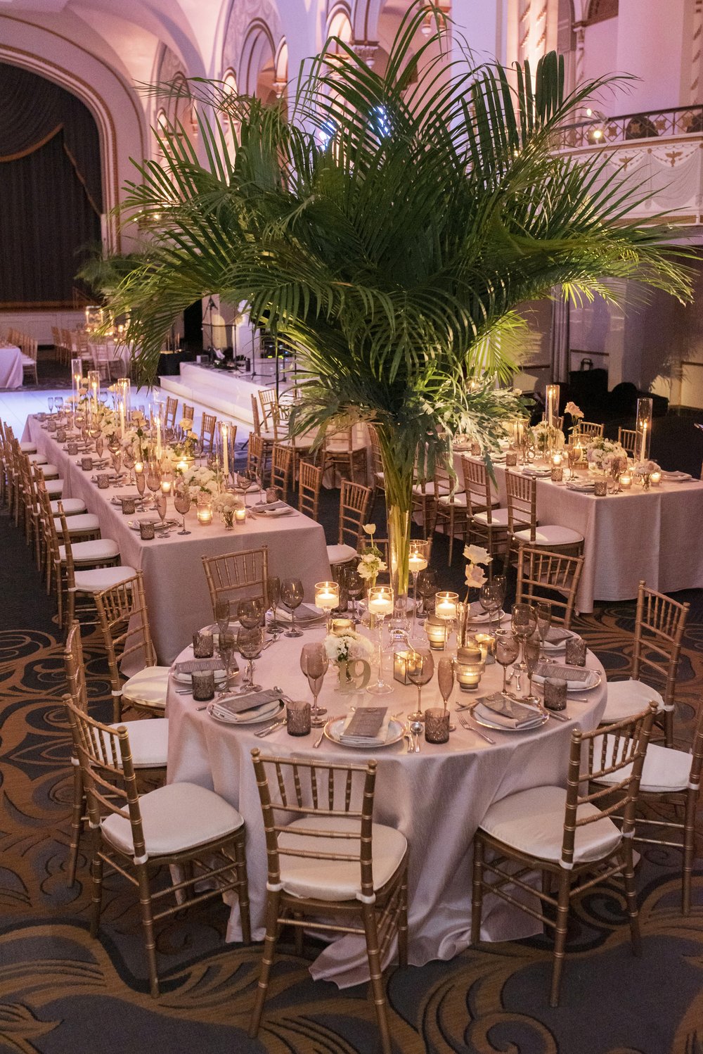 palm leaves on wedding reception tables