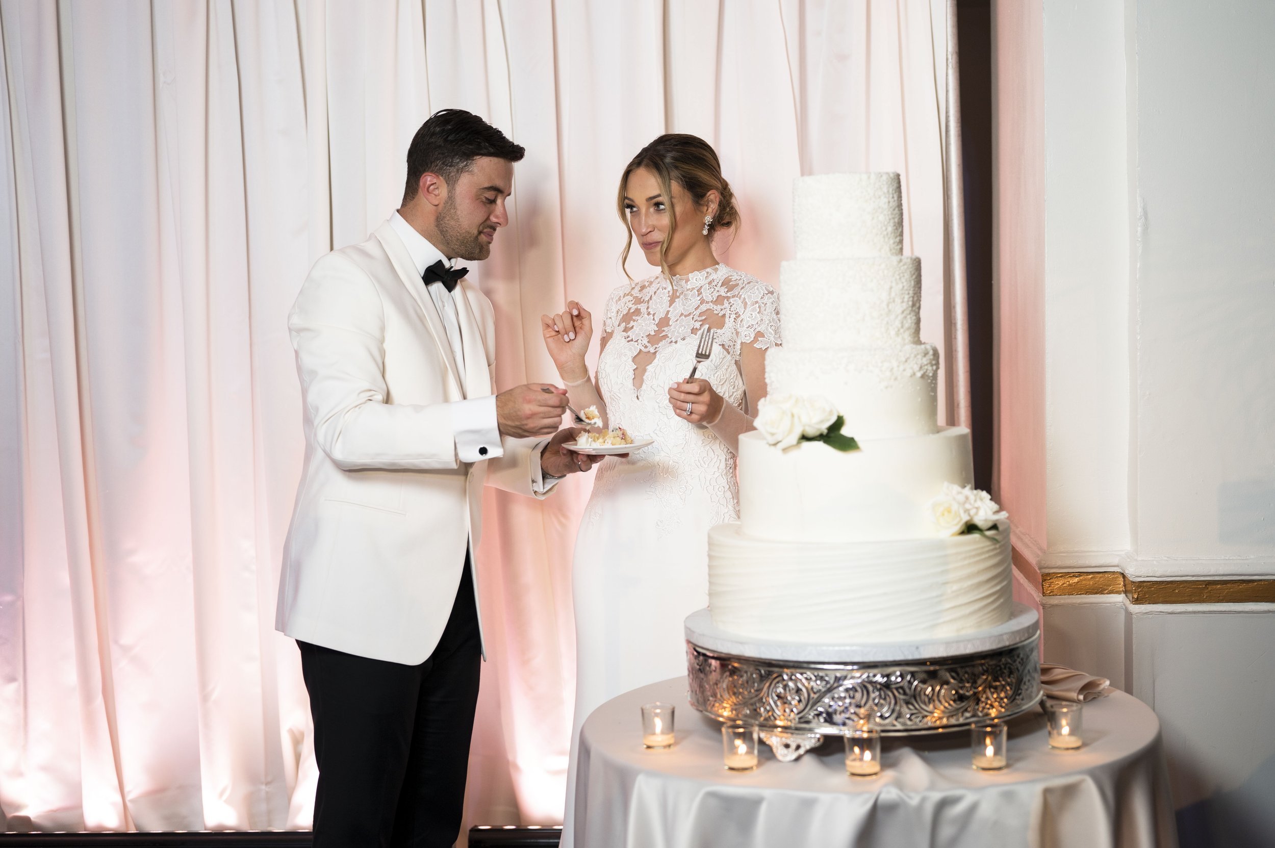 bride and groom cutting wedding cake