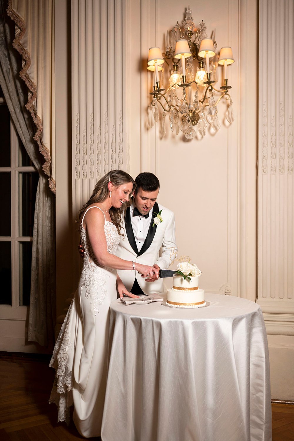  bride and groom cutting wedding cake 