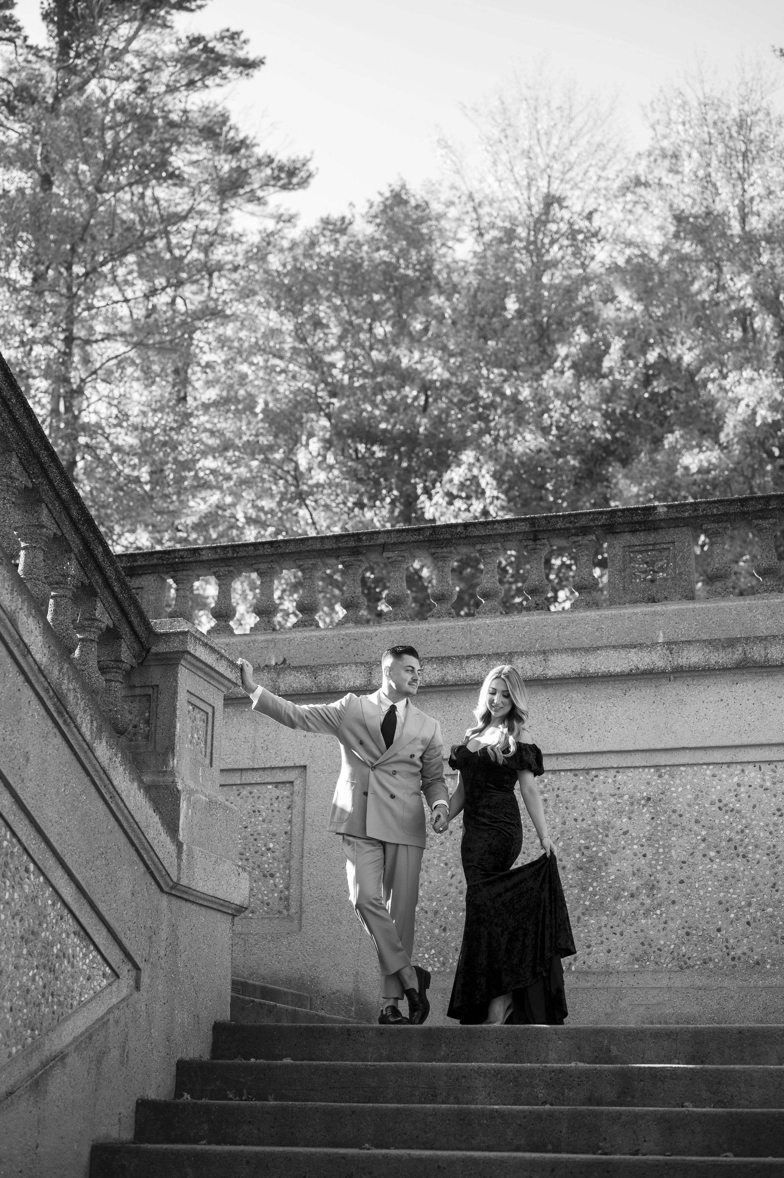 couple posing on stairs during engagement session