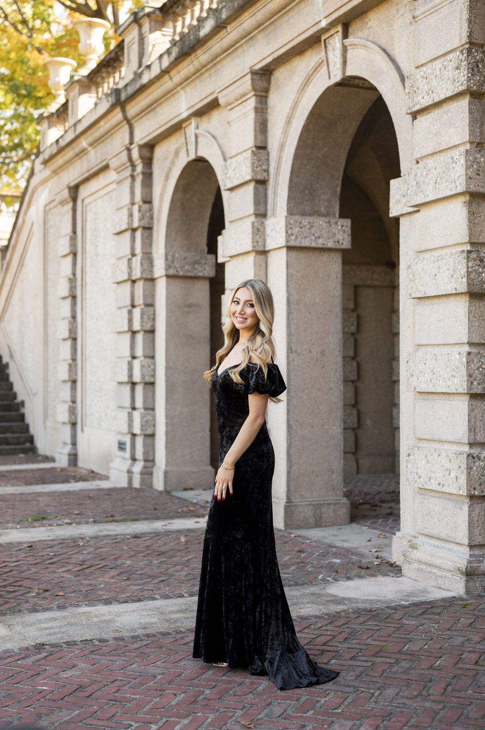 girl posing wearing black dress during engagement photos 