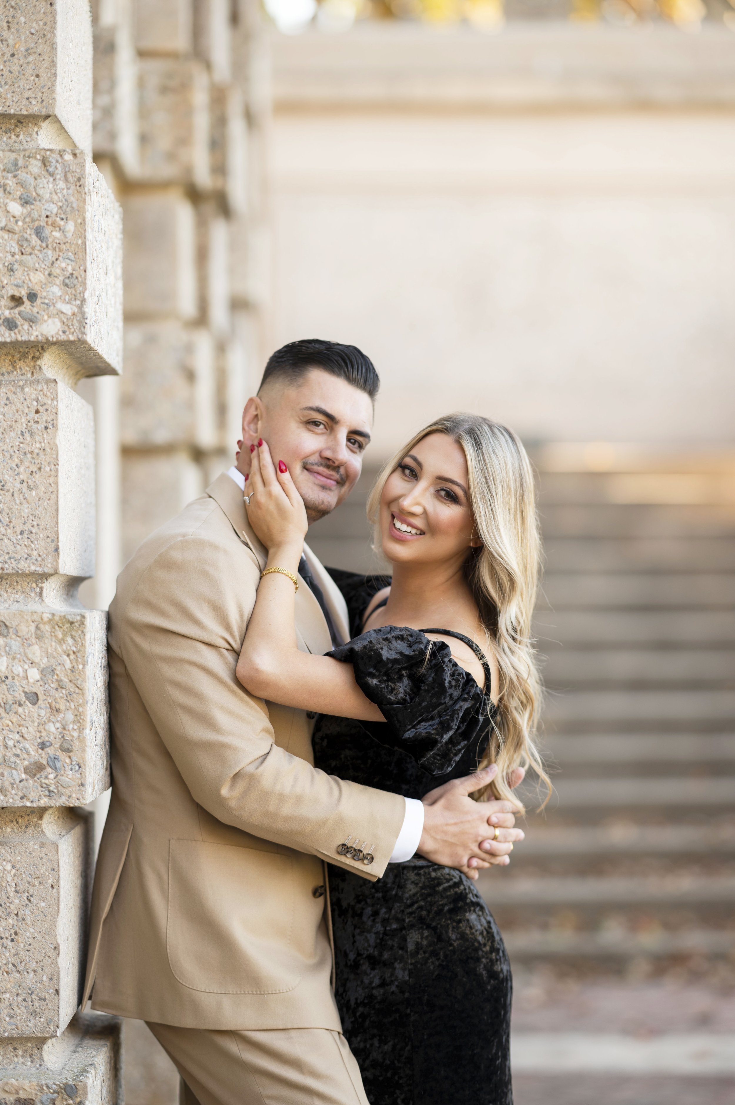 couple posing on stairs during engagement session