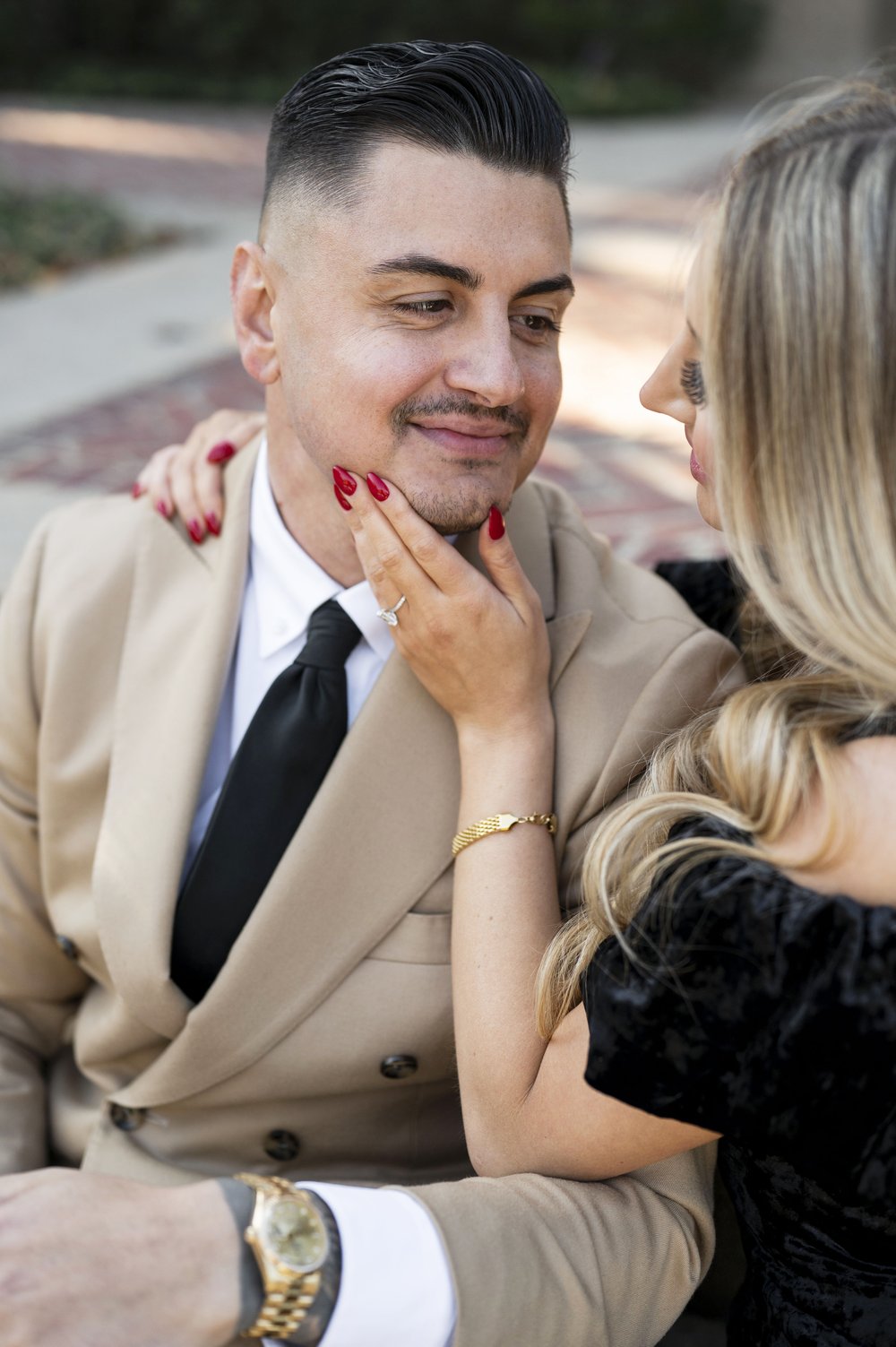 girl caressing face of man during engagement photos