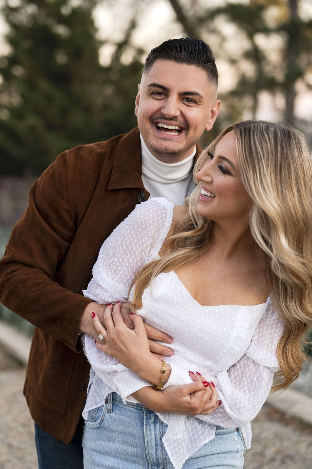 couple holding each other at outdoor engagement photos