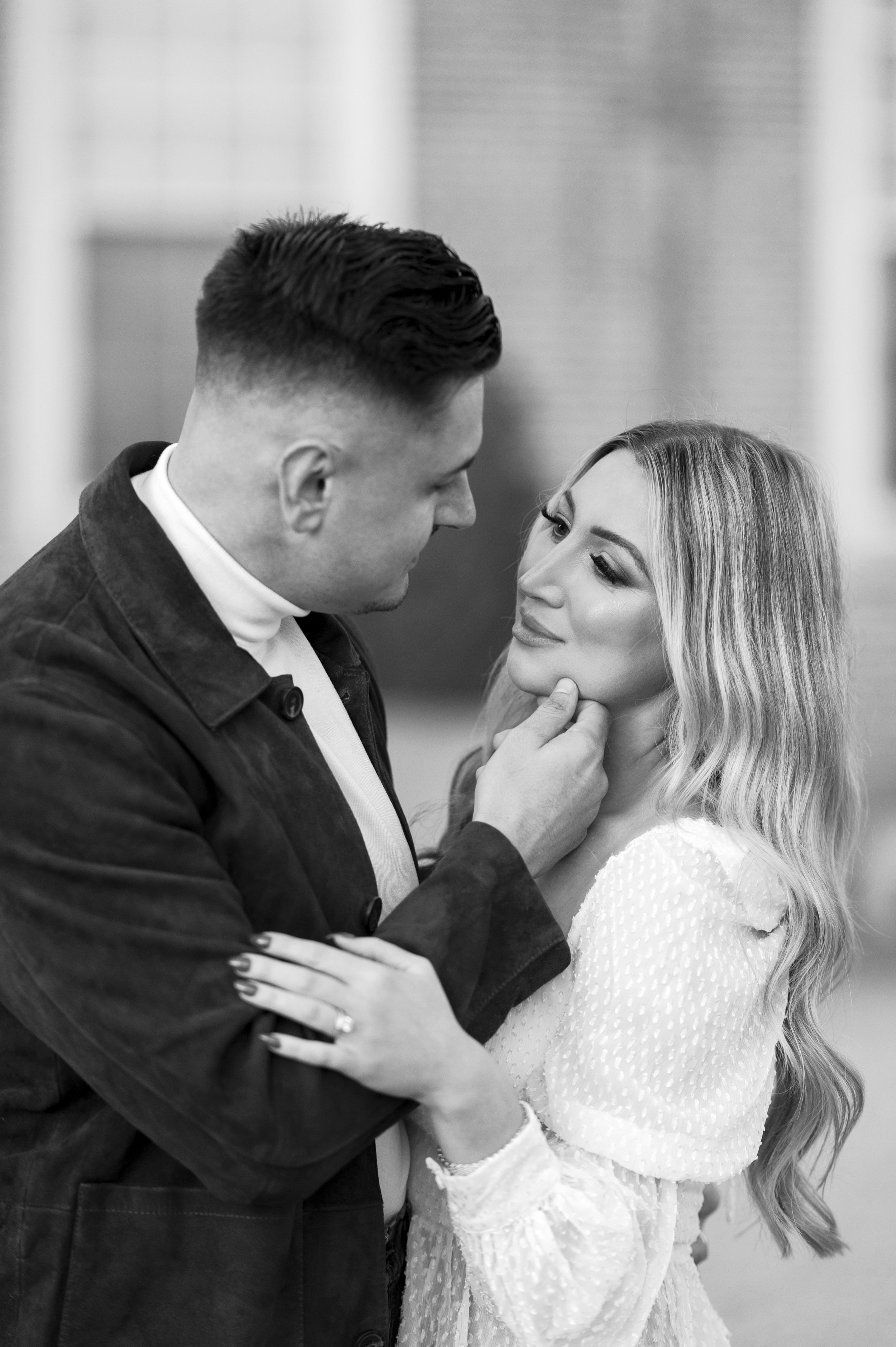 couple holding each other at outdoor engagement photos