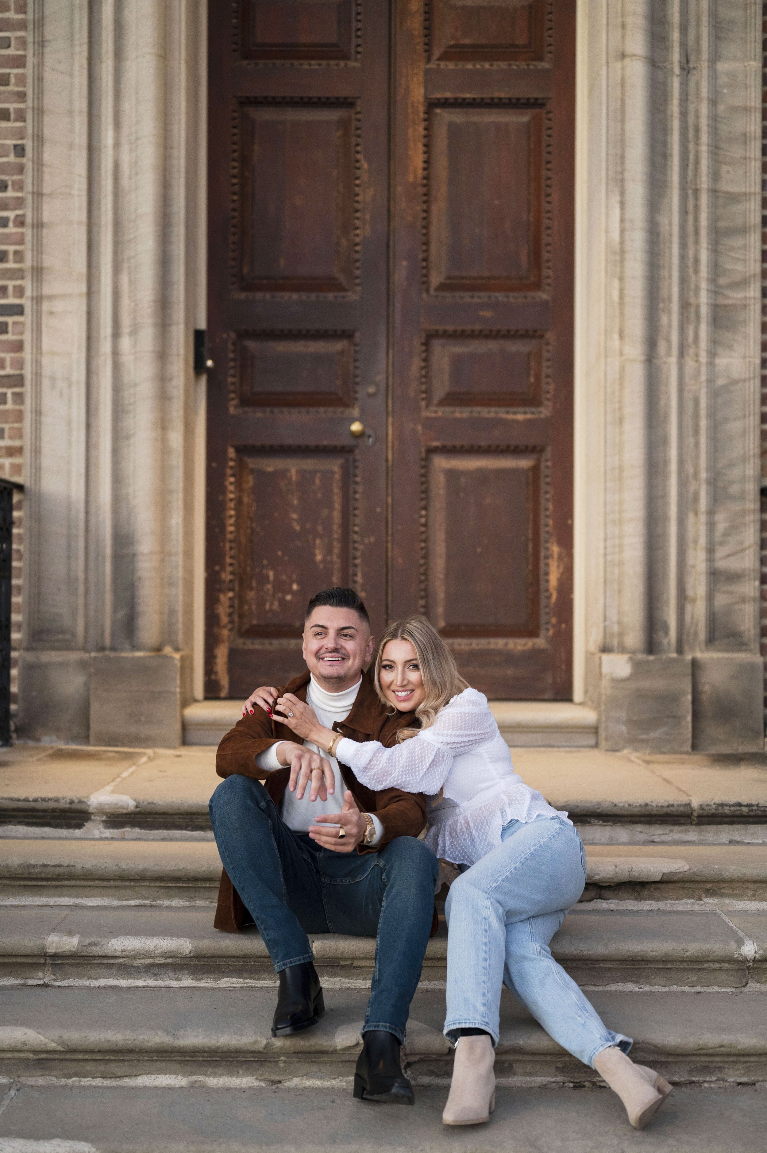 couple sitting on stairs at castle hill on the crane estate