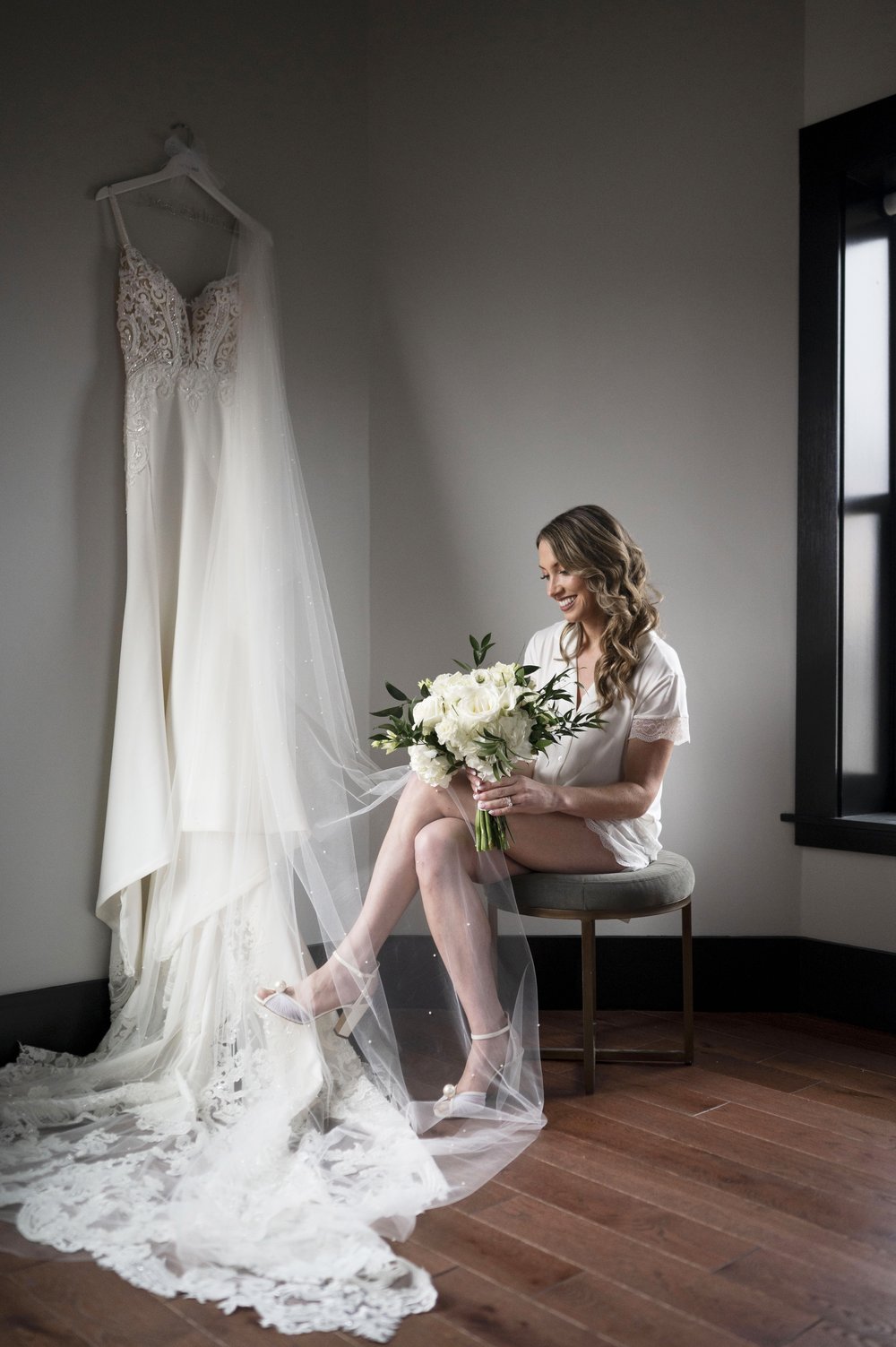 photo of bride sitting holding her bouquet