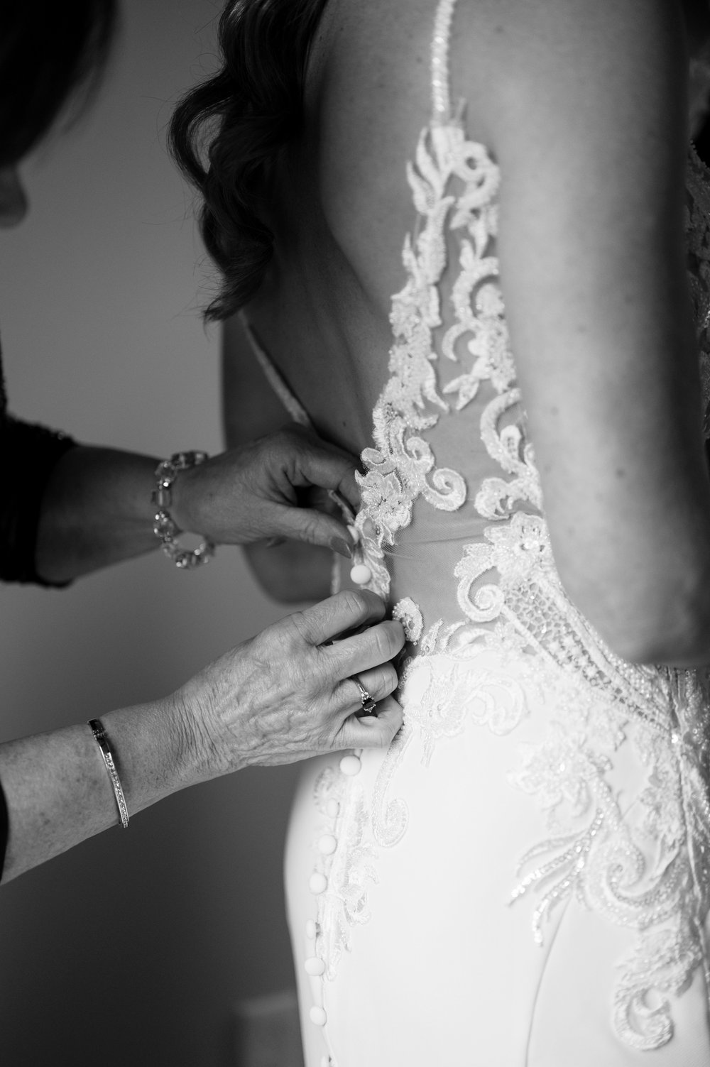 close up of hands sipping a wedding dress