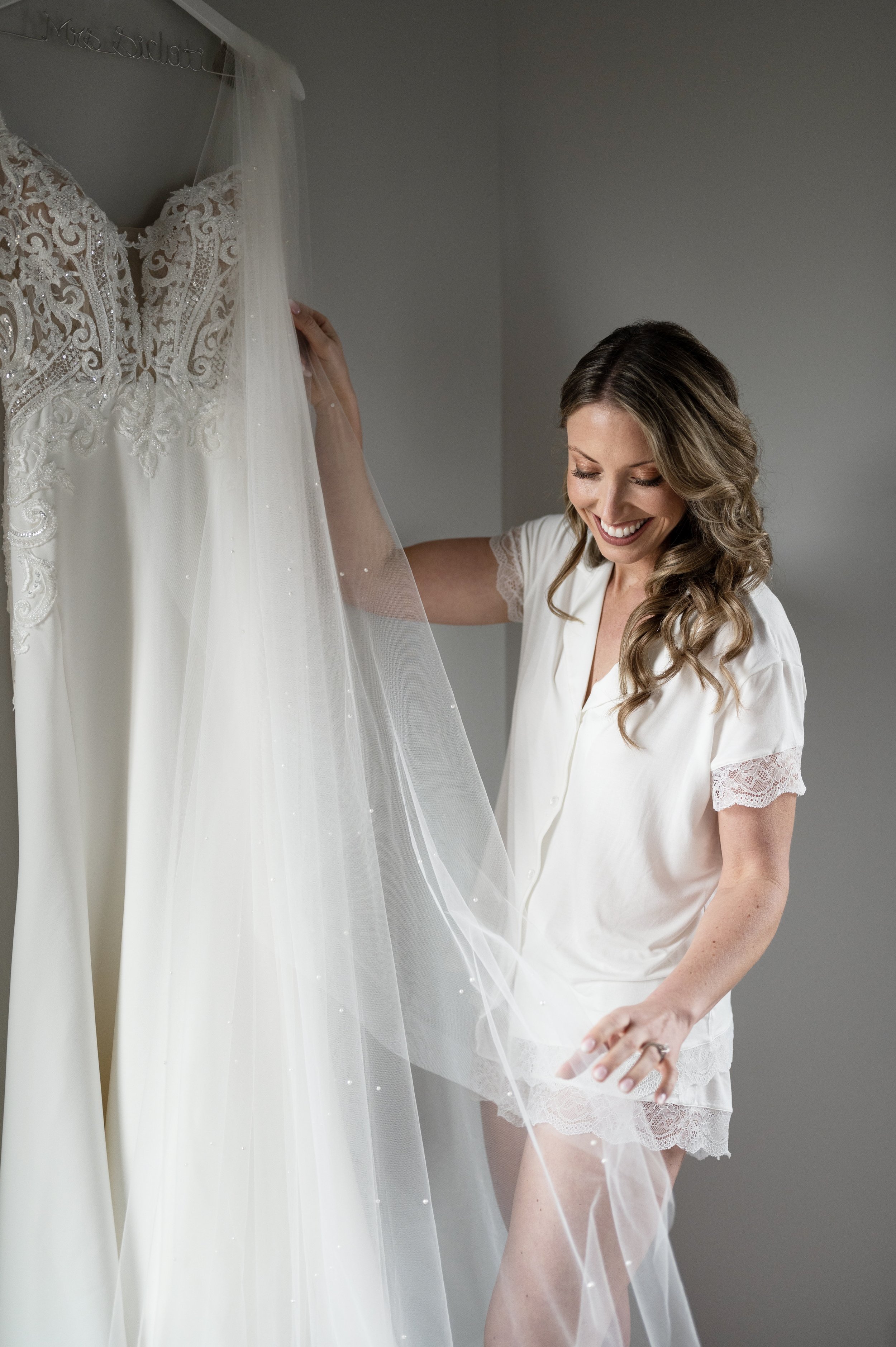 bride  looking at veil