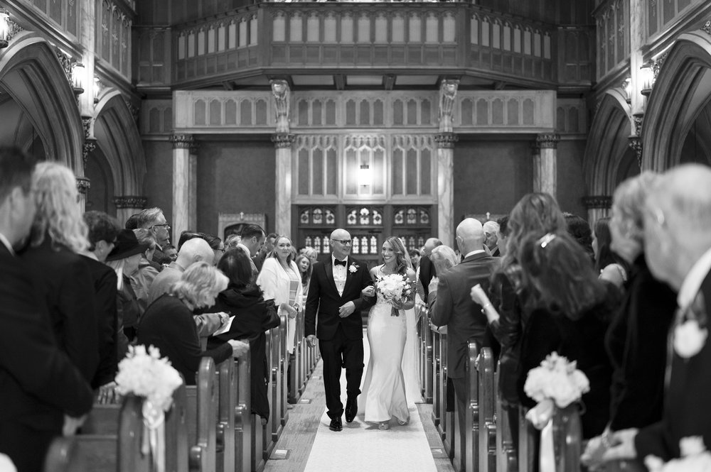 bride and father walking down the  isle in a church