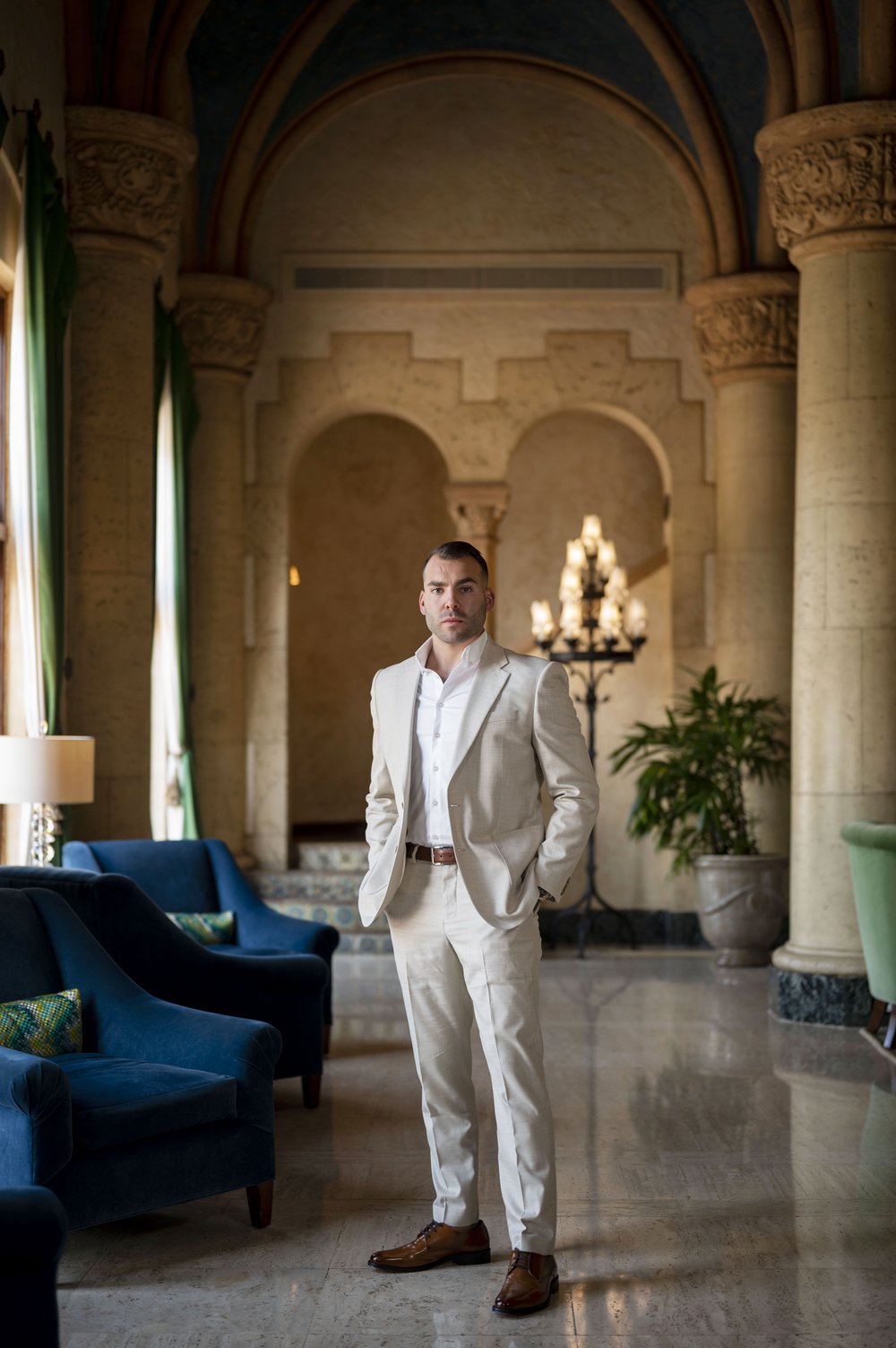 groom posing inside the bilmore hotel lobby