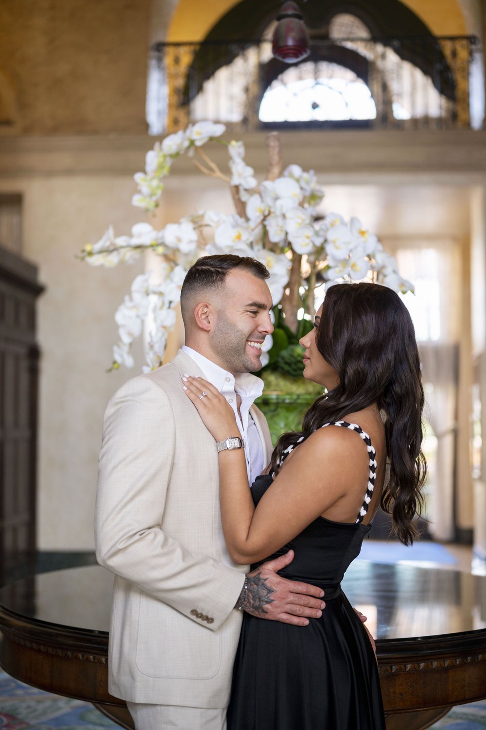 guy and girl hugging each other as they laugh inside the lobby at the Biltmore hotel