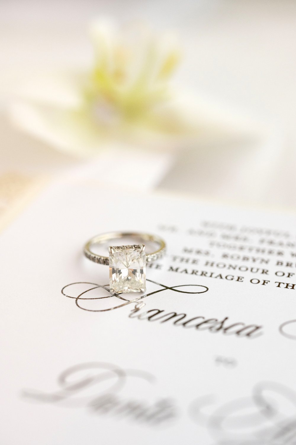 engagement ring on top of a wedding invitation