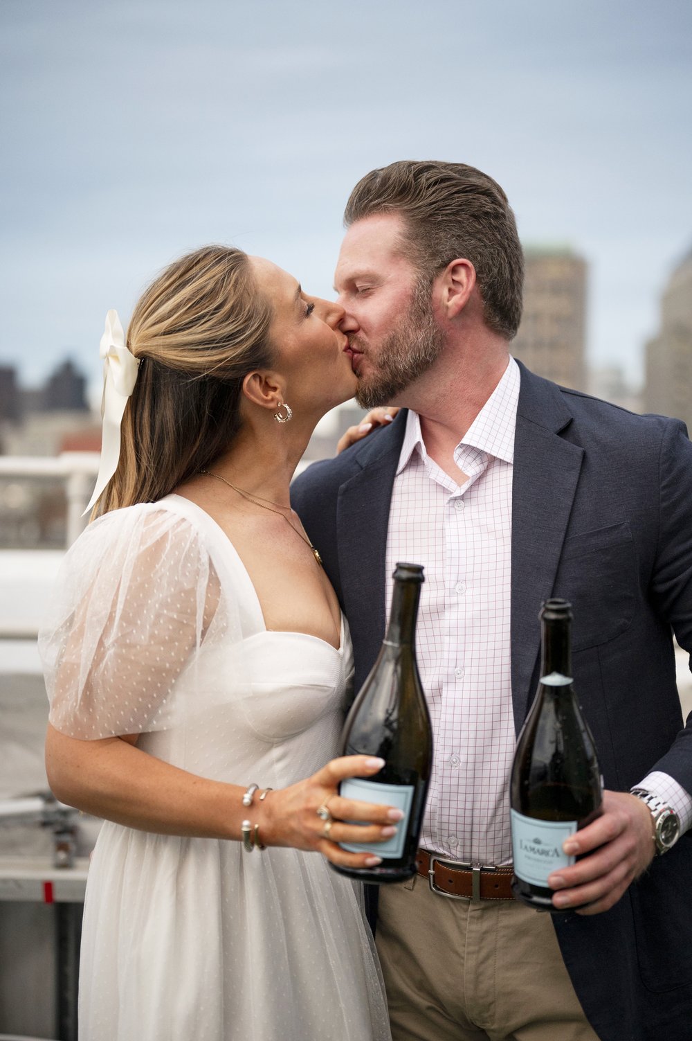 bride and groom kissing at the Lenox Hoel rooftop