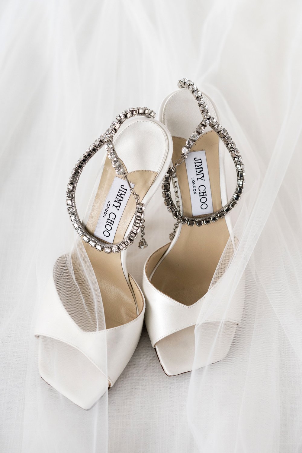 wedding shoes on top of a veil