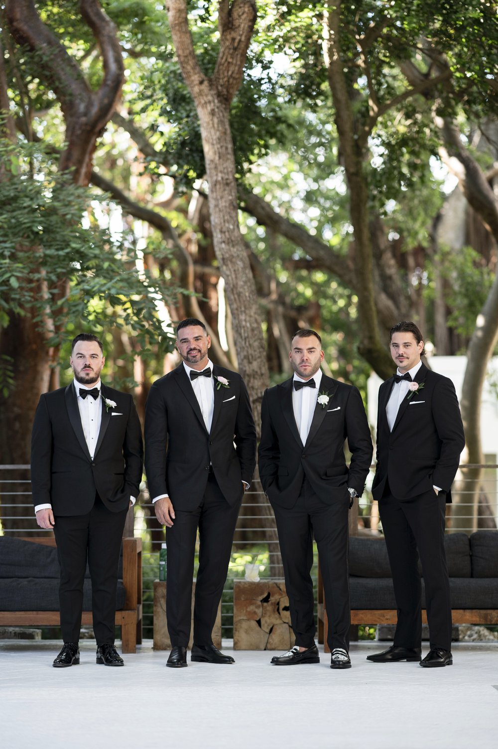 groom and groomsmen posing for the camera