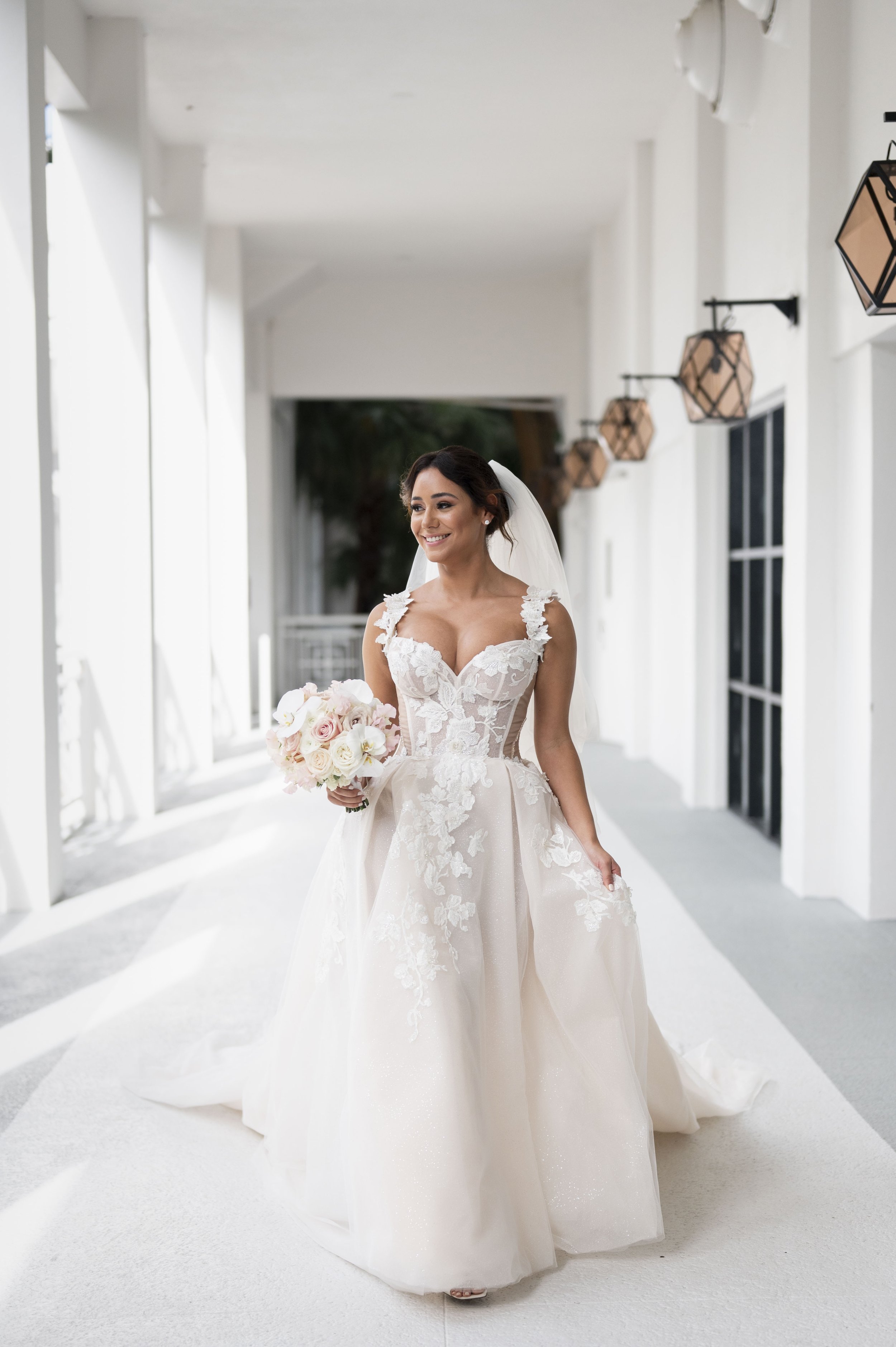 bride runs towears the camera in a white building