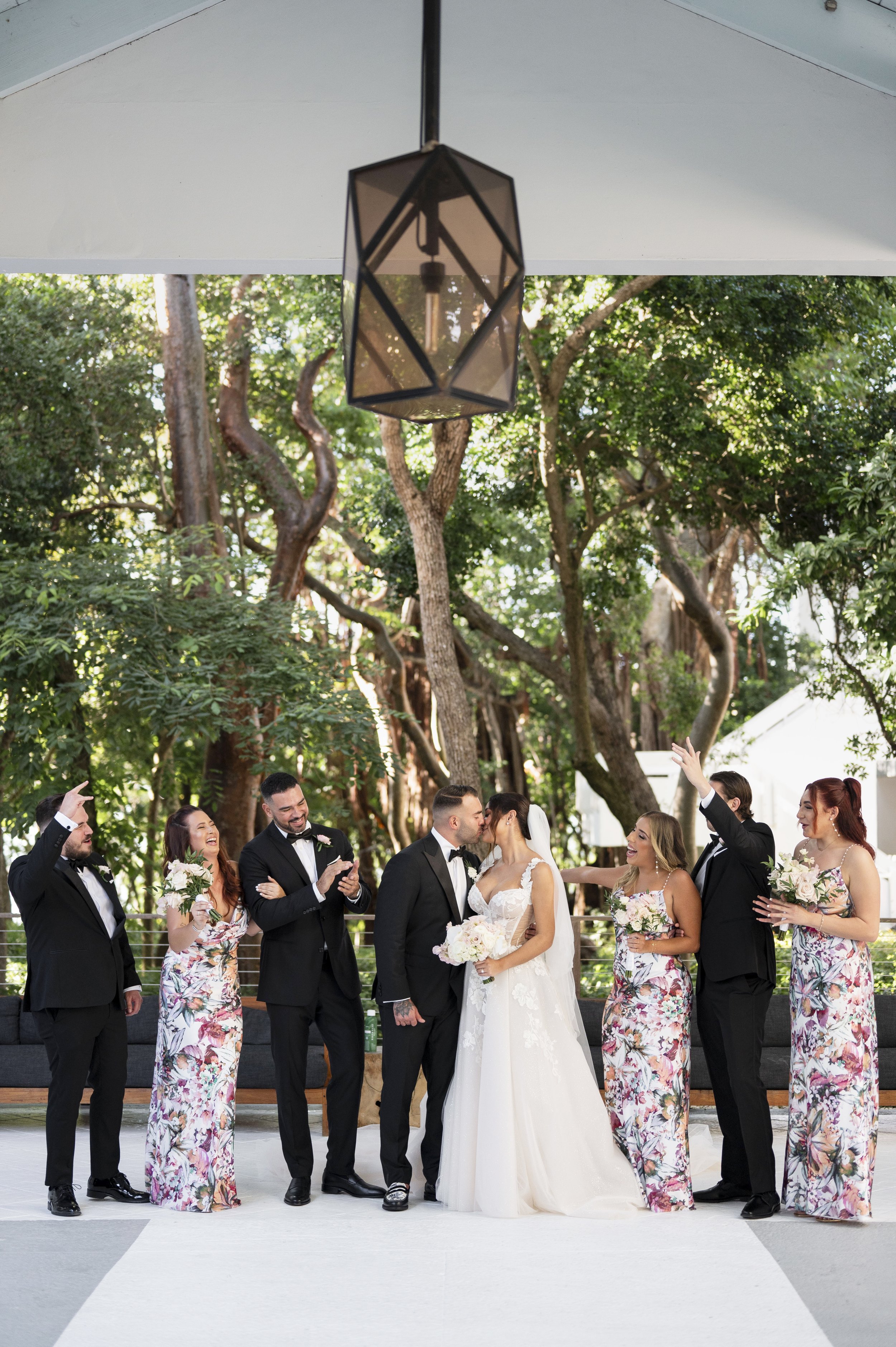 bride and groom posing with the bridal party