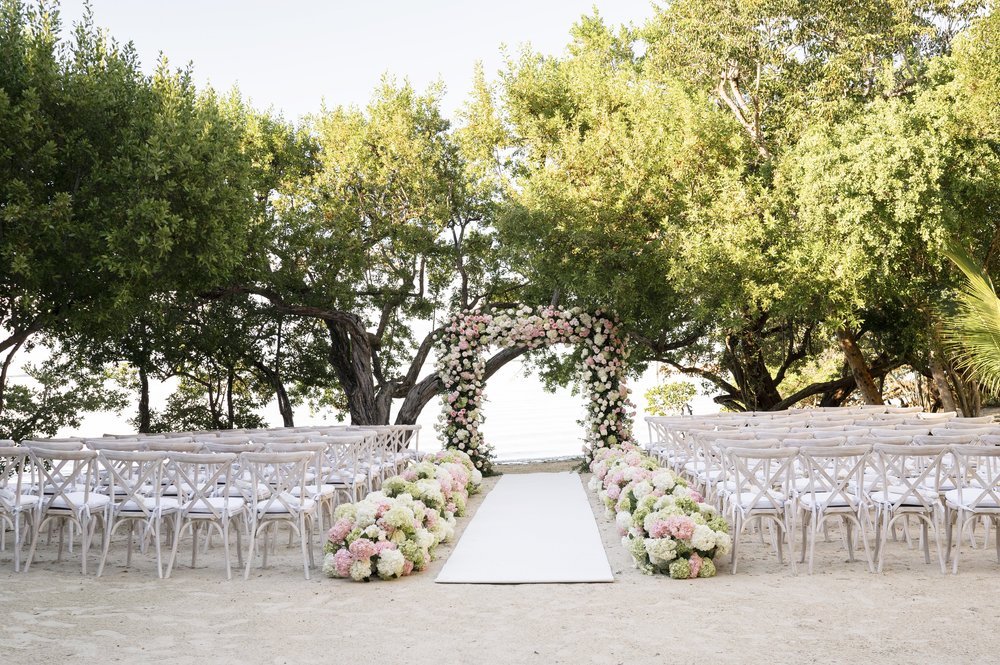 ceremony area design with floers and chairs in a beach area