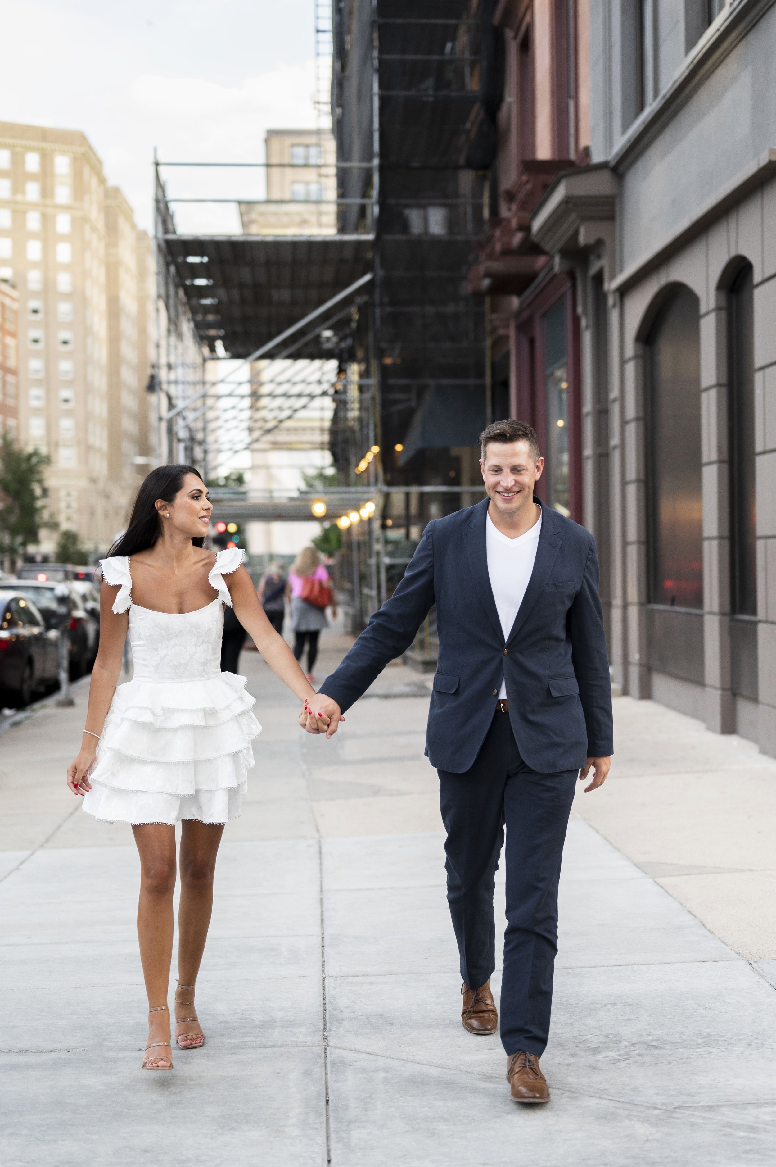 girl and guy walking the streets of boston holding hands