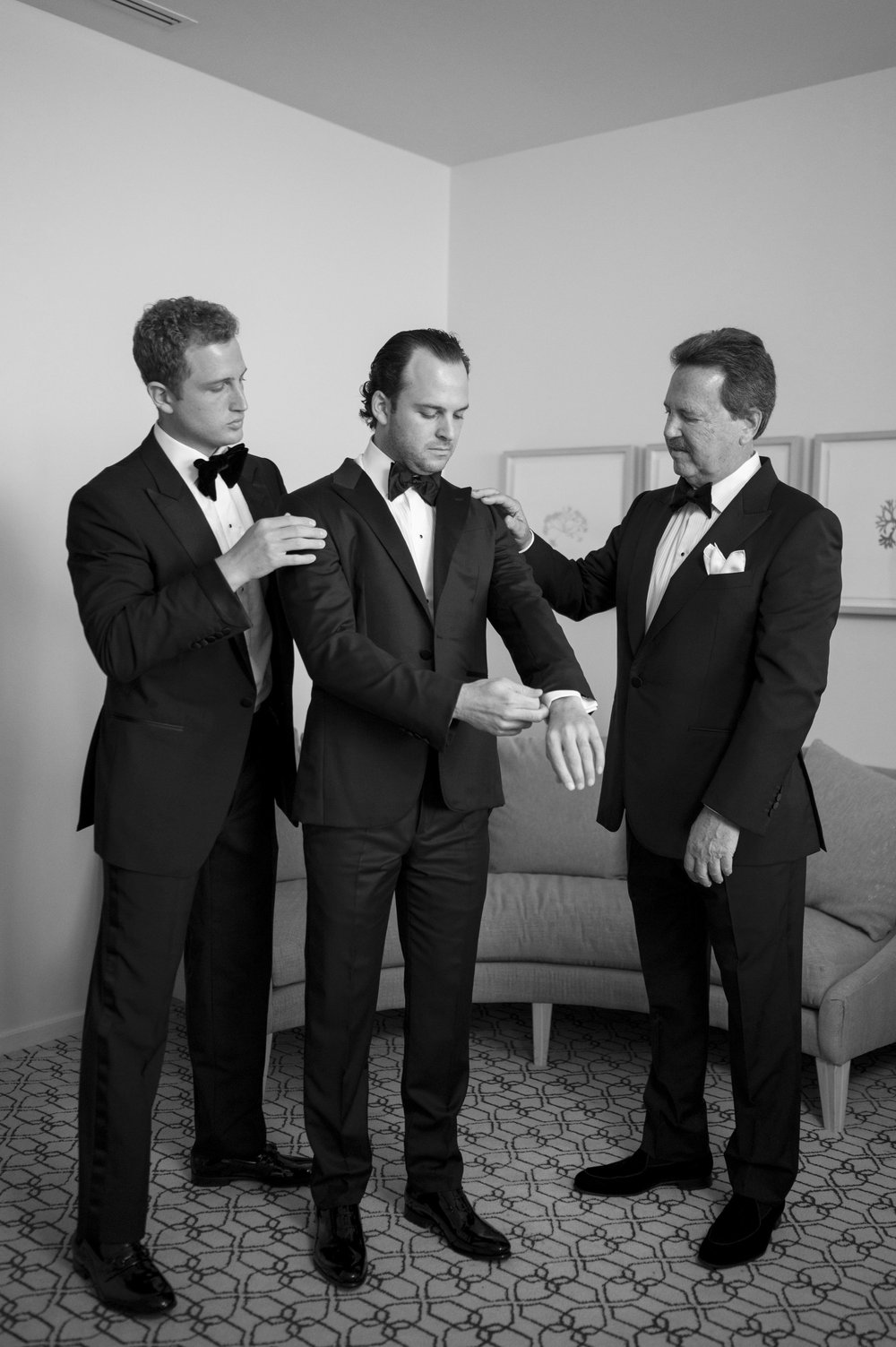 groom wearing tuxedo getting ready