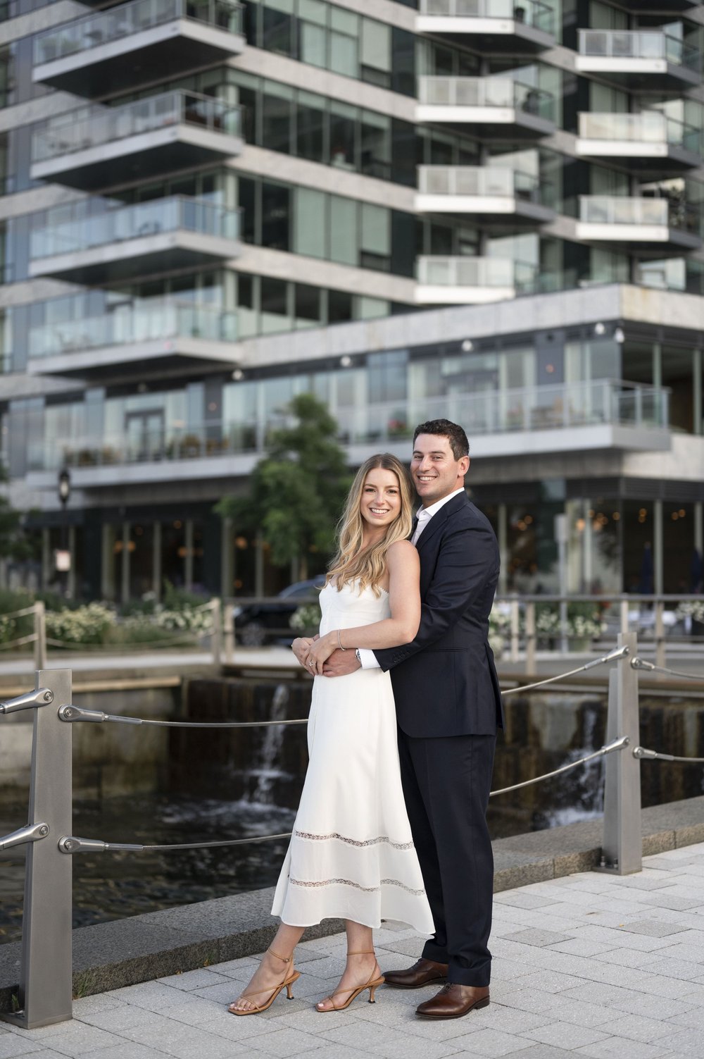 bride and groom posing  in the boston seaport area