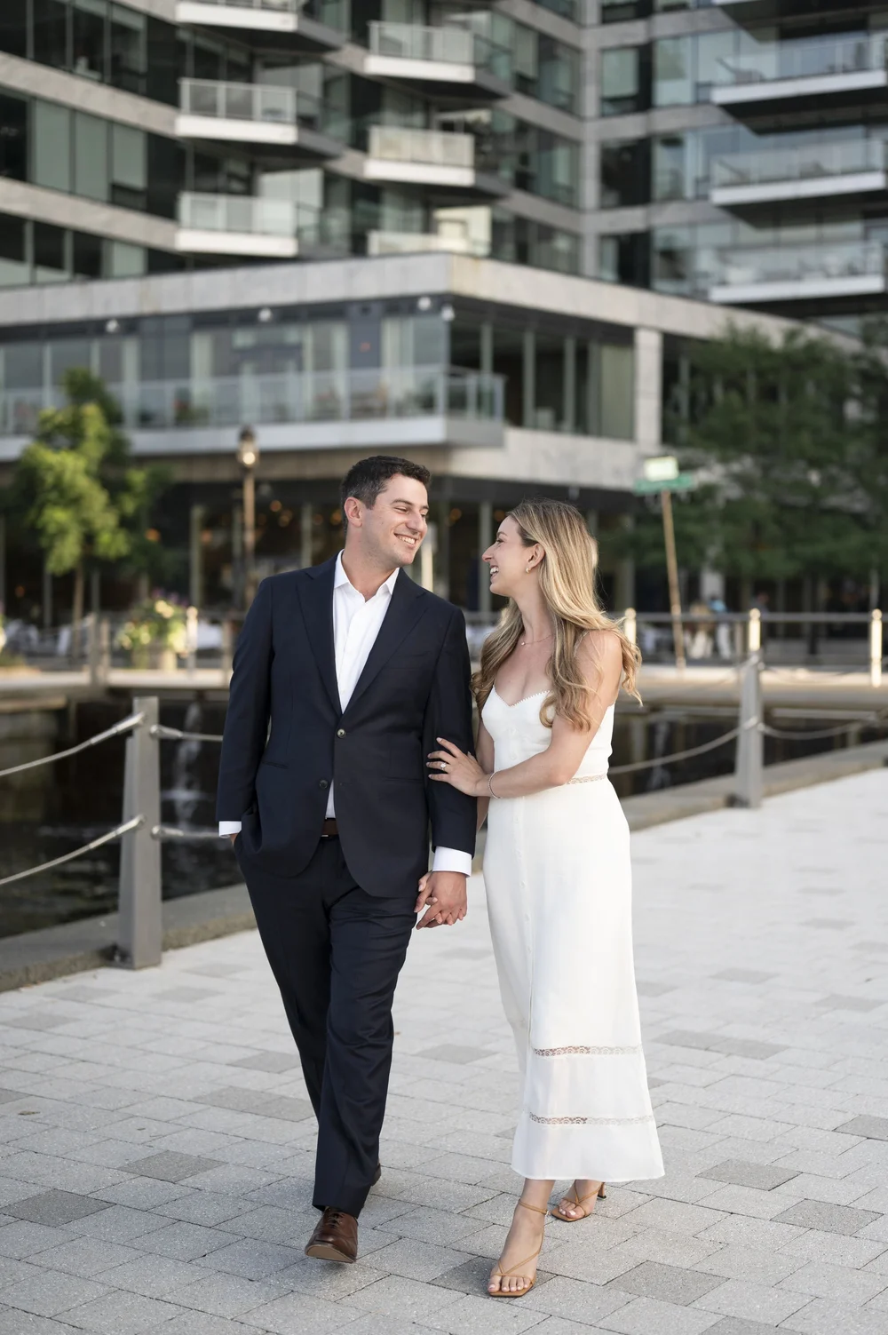 bride and groom walking in the boston harbor