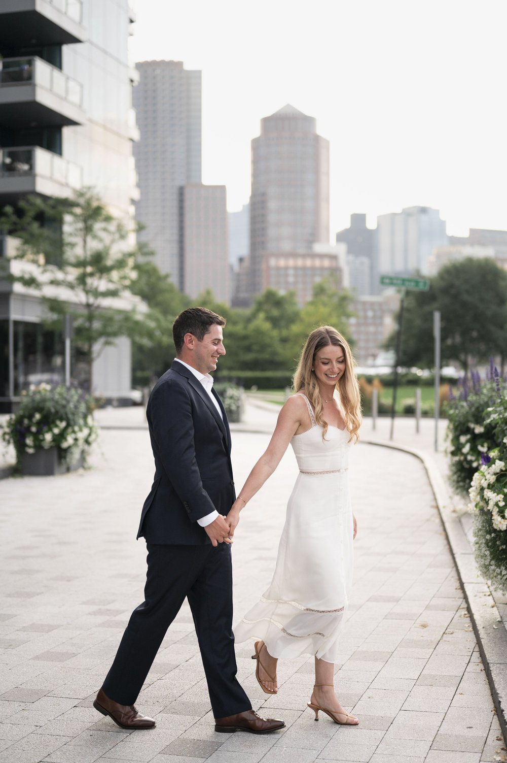 bride and groom crossing a street at boston seaport