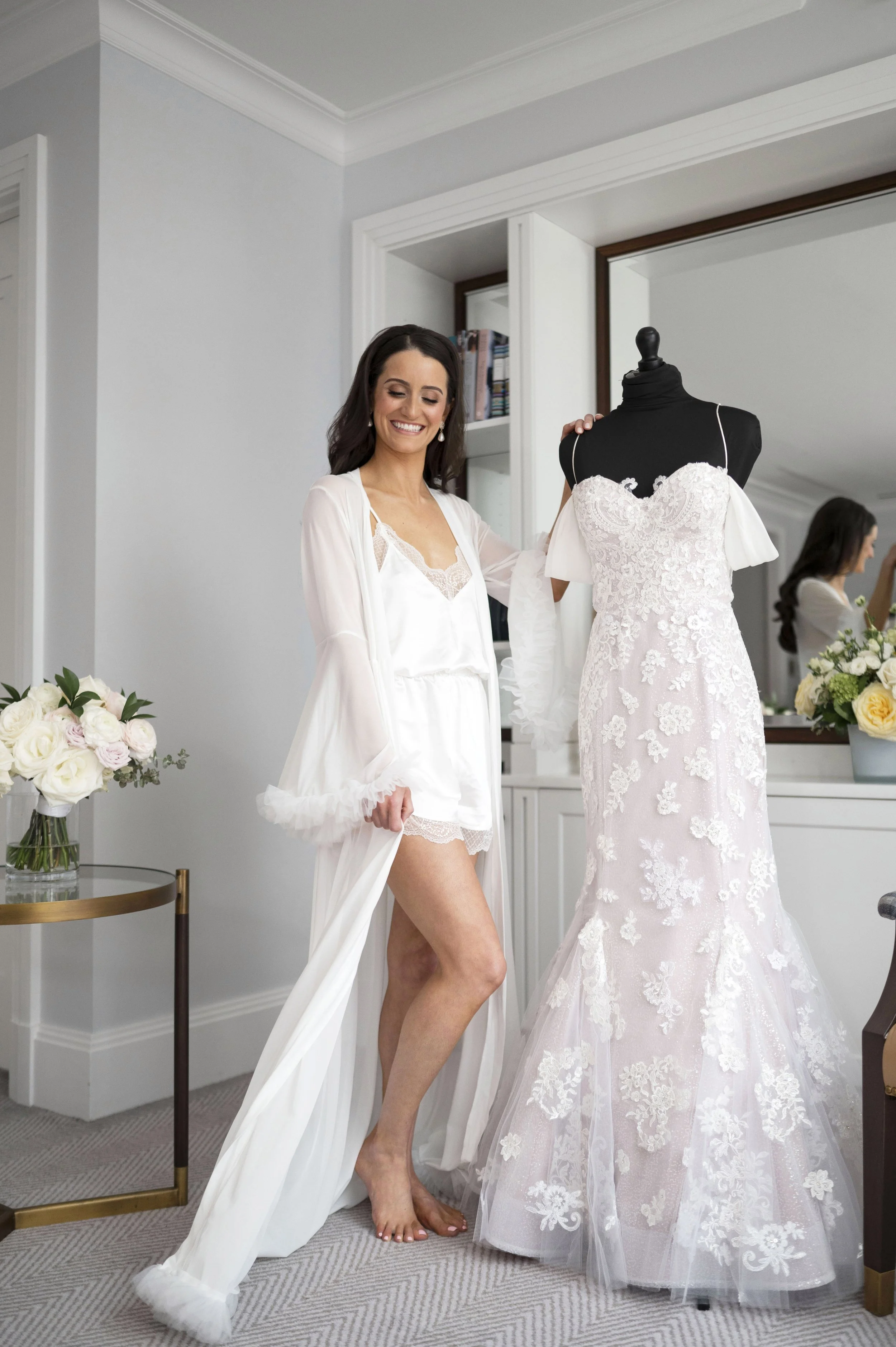 bride posing next to her dress