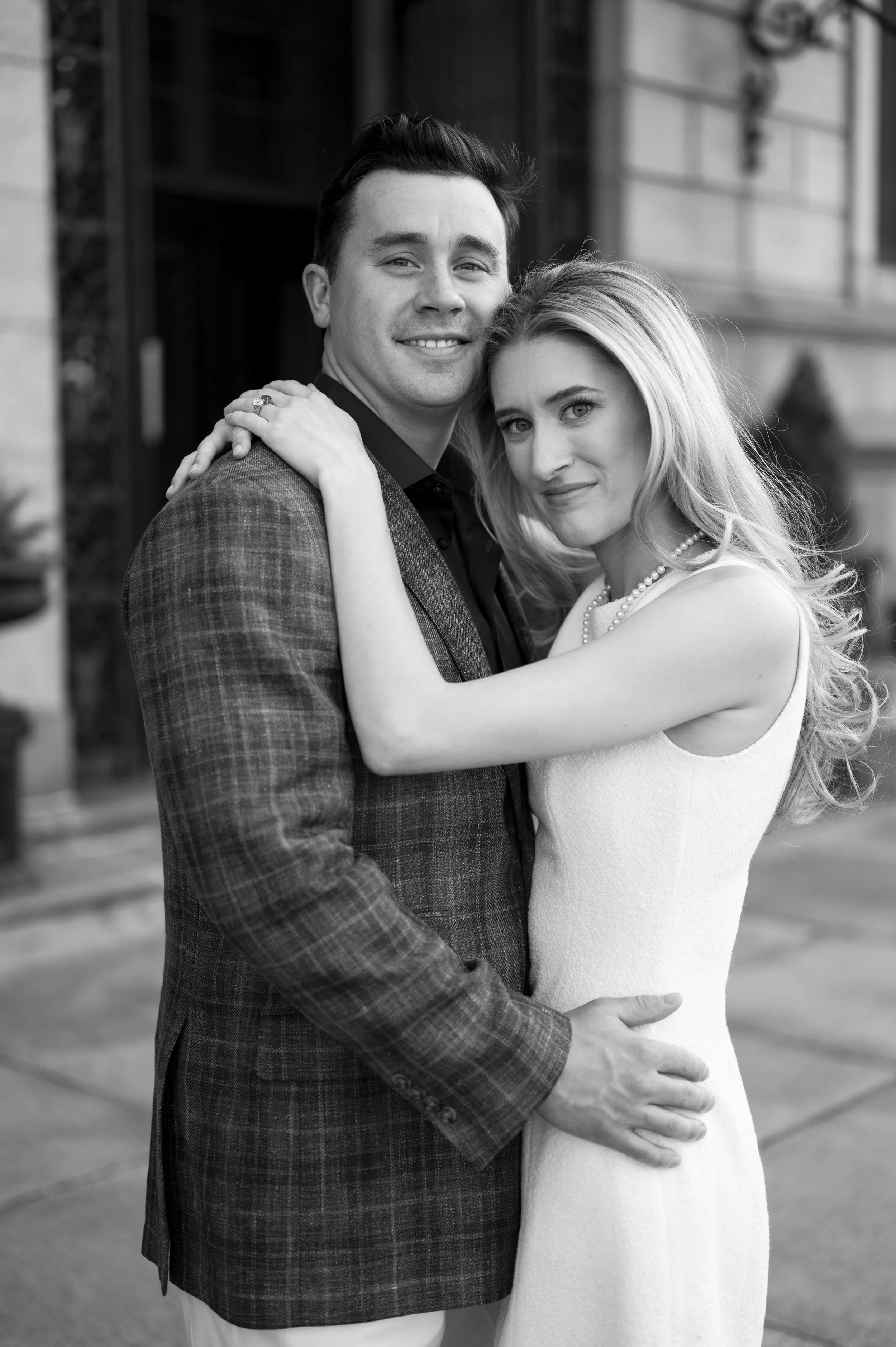 Cathryn and Brendan hugging in front of the Boston Public Library during their engagement session