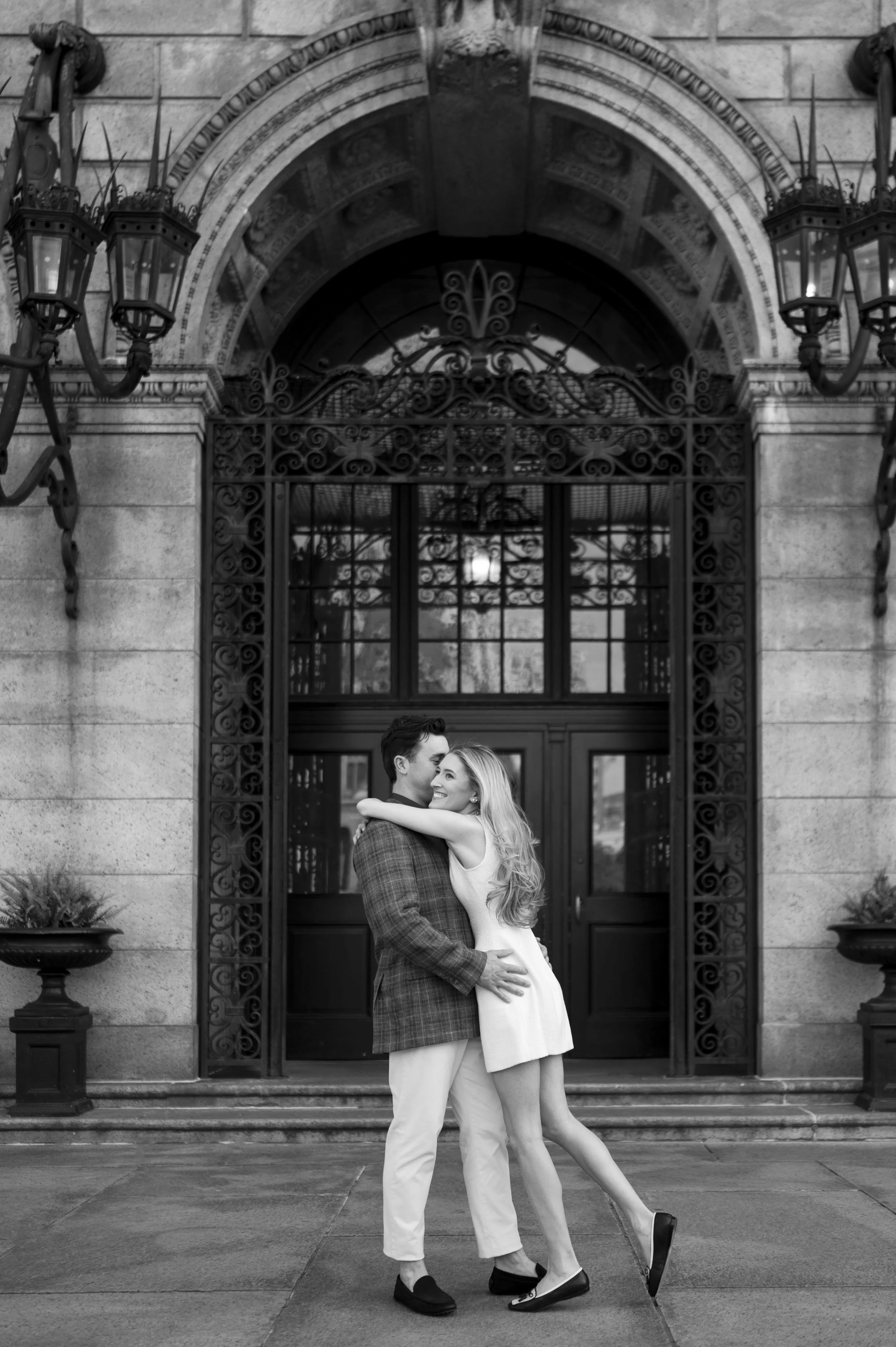 Cathryn and Brendan hugging in front of the Boston Public Library during their engagement session