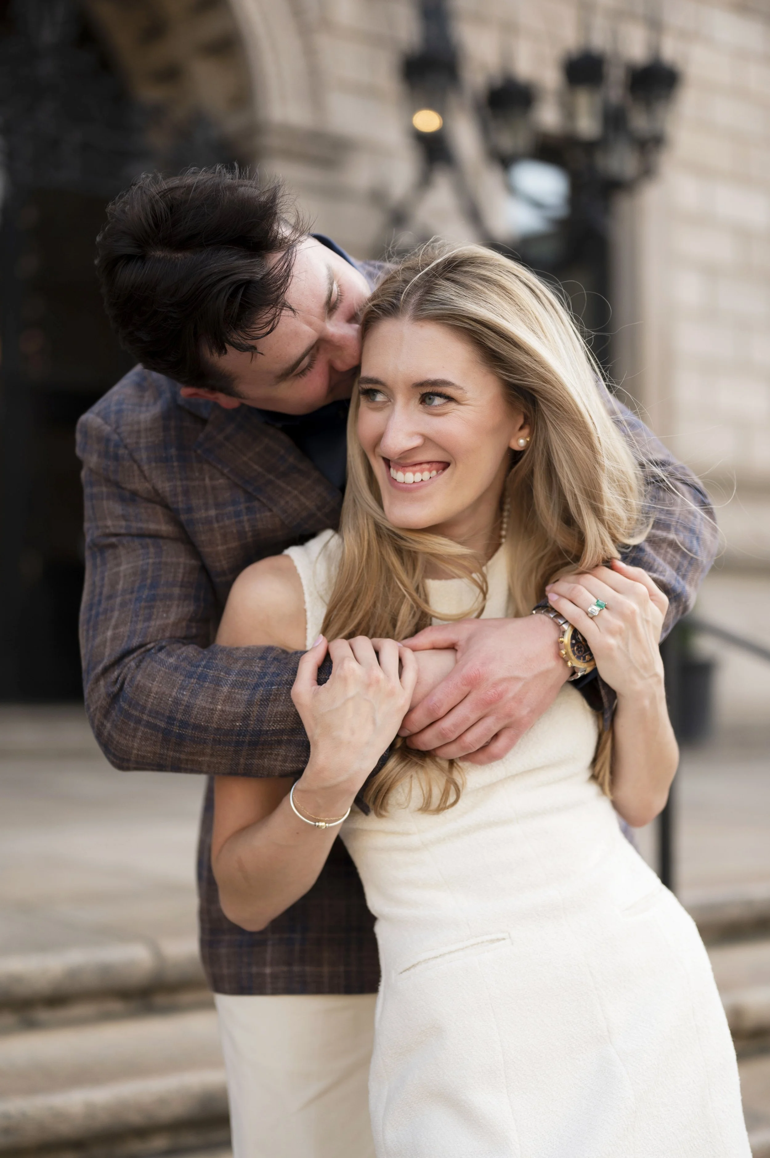 Cathryn and Brendan hugging at the stairs of boston public library during their engagement session